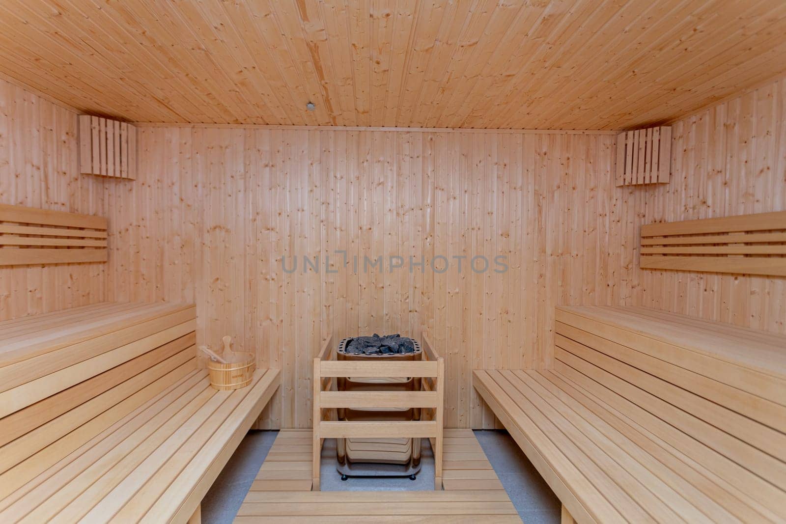 The interior of a calm and peaceful wooden sauna offers an ideal setting for deep relaxation and health rejuvenation