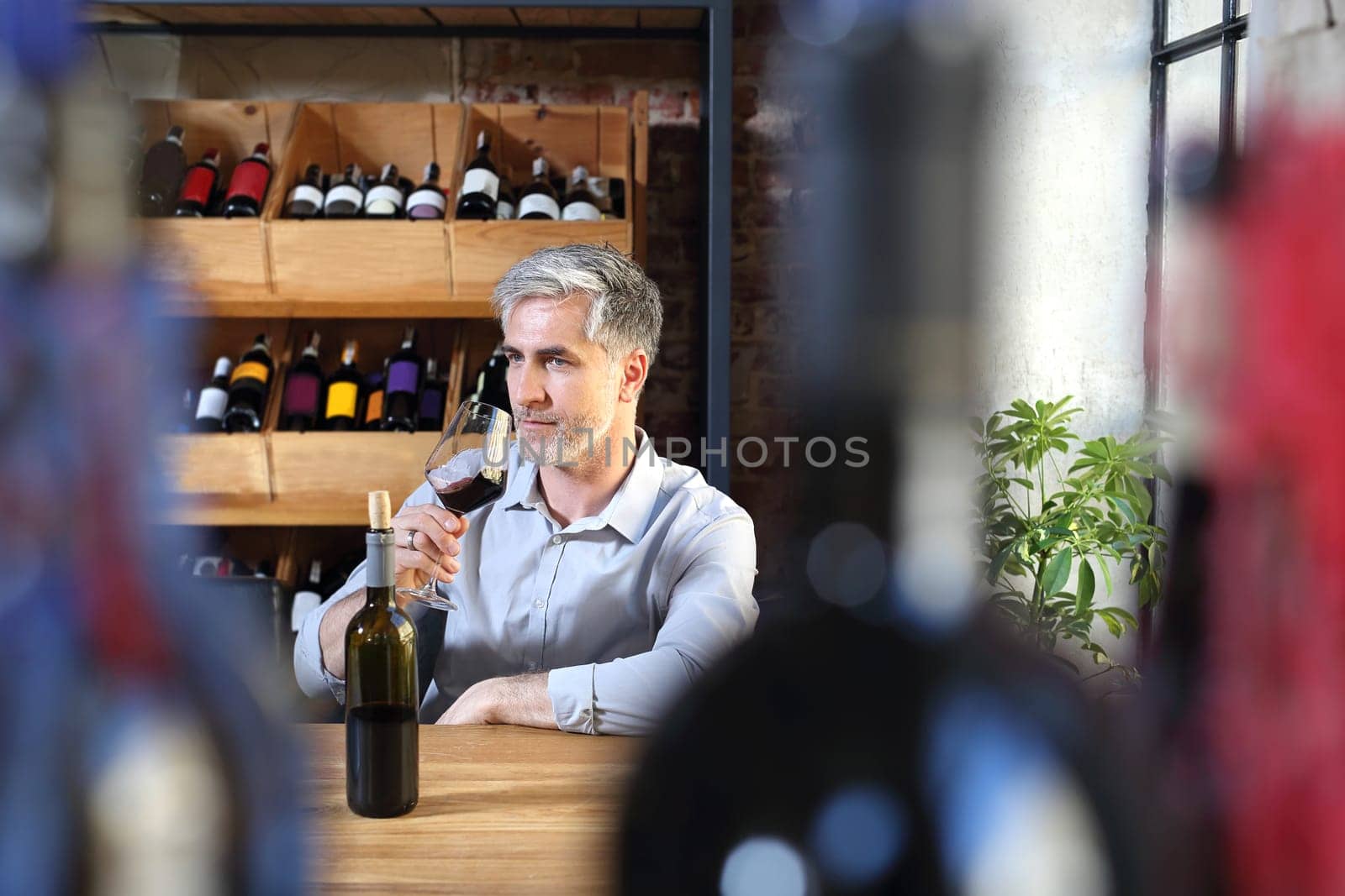 A glass of red wine. Handsome man drinking wine. Man drinking wine.