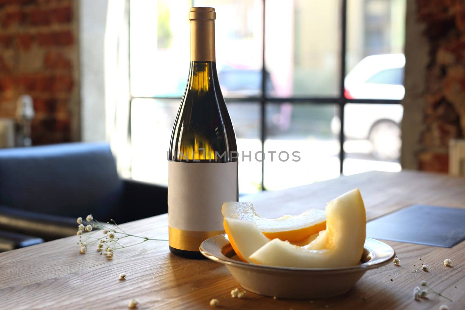 Aperitif, a glass of white wine and melon.
