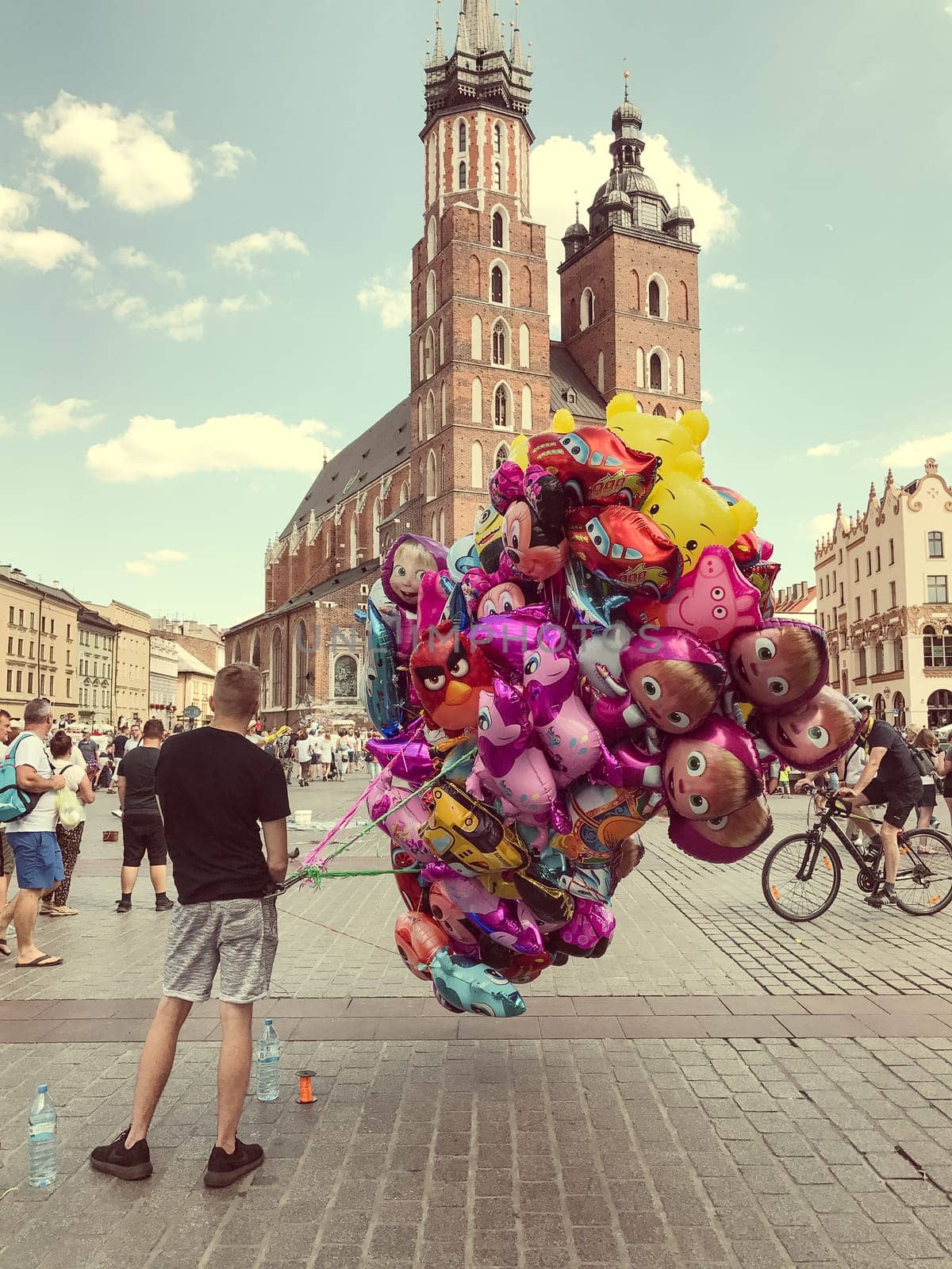 Krakow, Poland - July 29, 2017 : Male street vendor sells colorful popular cartoon character helium balloons
