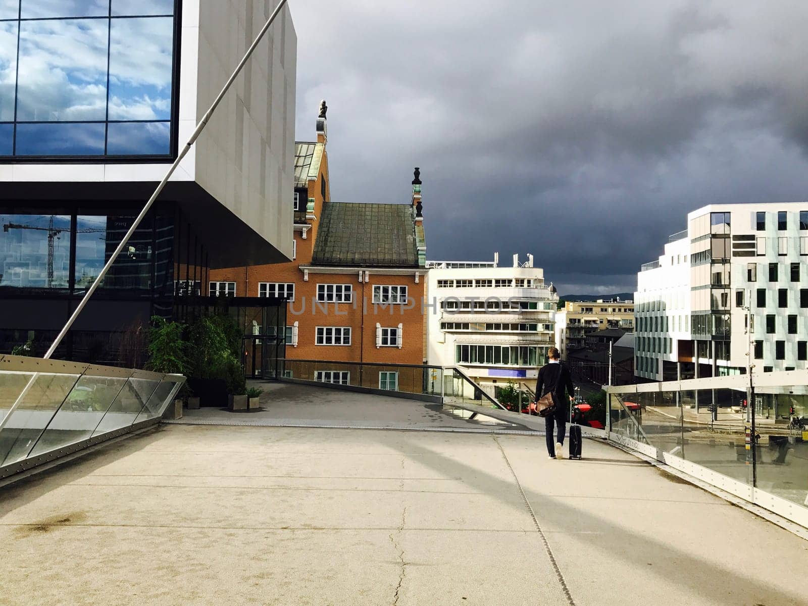 One businessman with luggage goes to the station, A man heading off on a business trip. Thunderstorm is coming