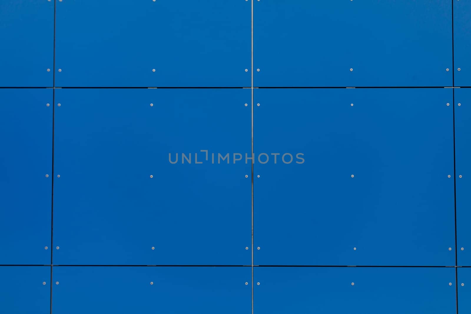 A closeup view capturing a vibrant blue wall, showcasing textured panels with clearly visible seams and details