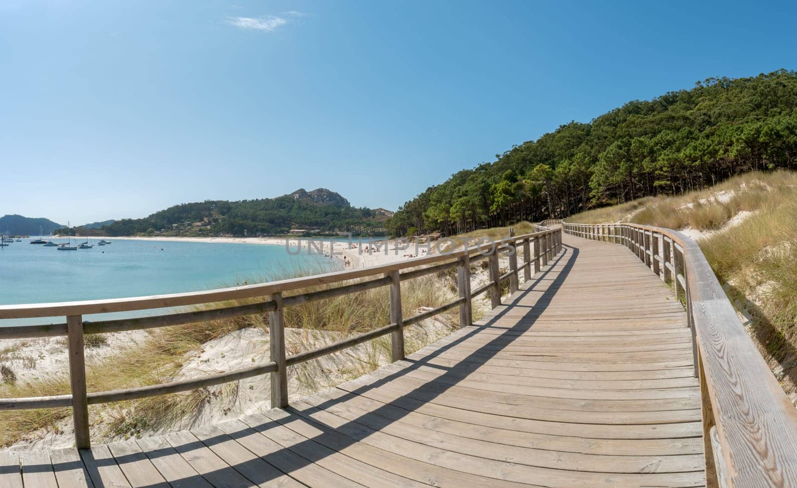 ISLAS CIES, SPAIN - CIRCA SEPTEMBER 2017: Wooden courseway along the sand beach of Playa de Rodas on the Cies Islands of Spain, included in the Atlantic Islands of Galicia National Park.