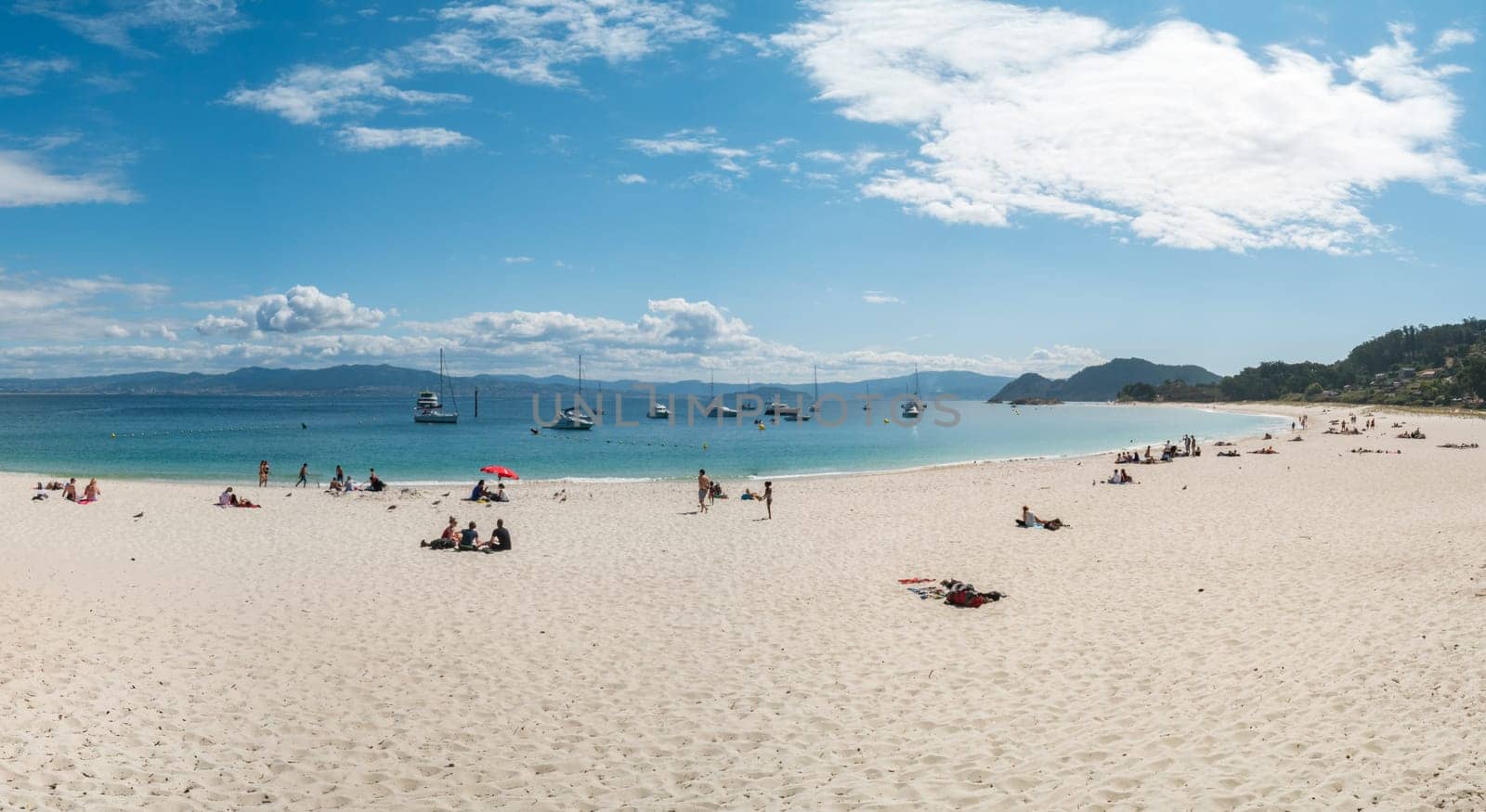 ISLAS CIES, SPAIN - CIRCA SEPTEMBER 2017: Unidentified people relax on the sand beach of Playa de Rodas on the Cies Islands of Spain, included in the Atlantic Islands of Galicia National Park.