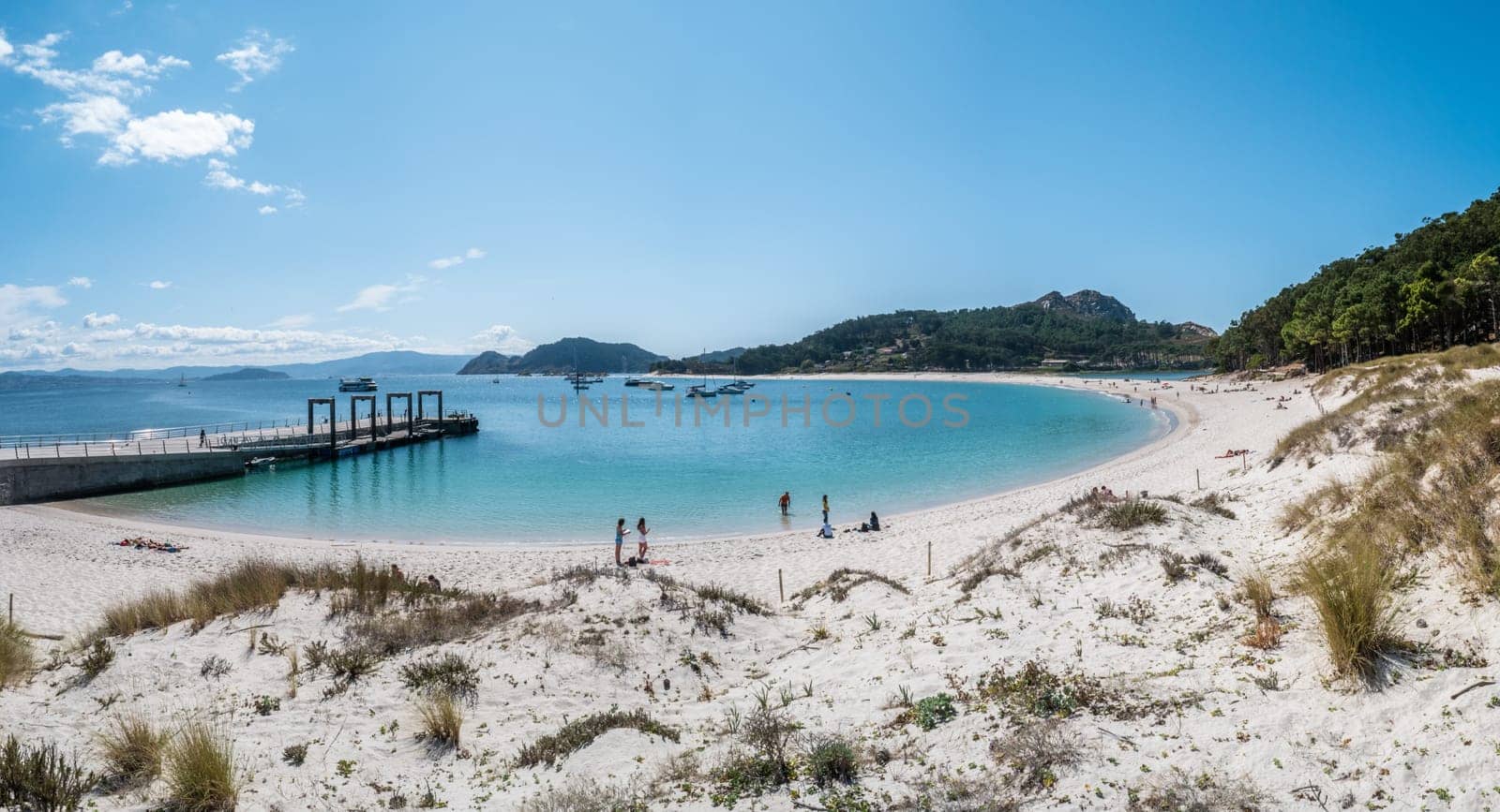 ISLAS CIES, SPAIN - CIRCA SEPTEMBER 2017: Unidentified people relax on the sand beach of Playa de Rodas on the Cies Islands of Spain, included in the Atlantic Islands of Galicia National Park.