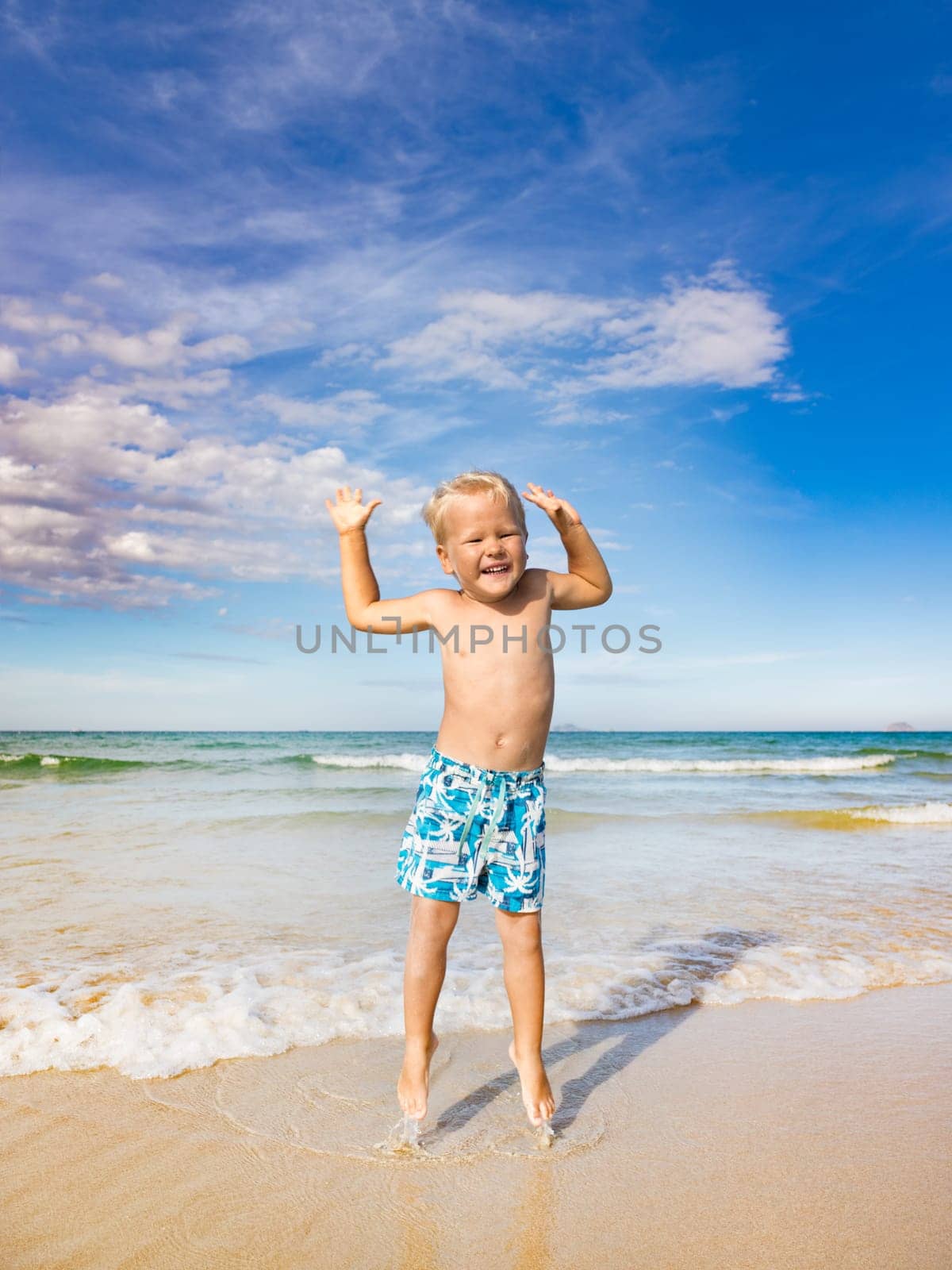 Cute boy jumping on the beach