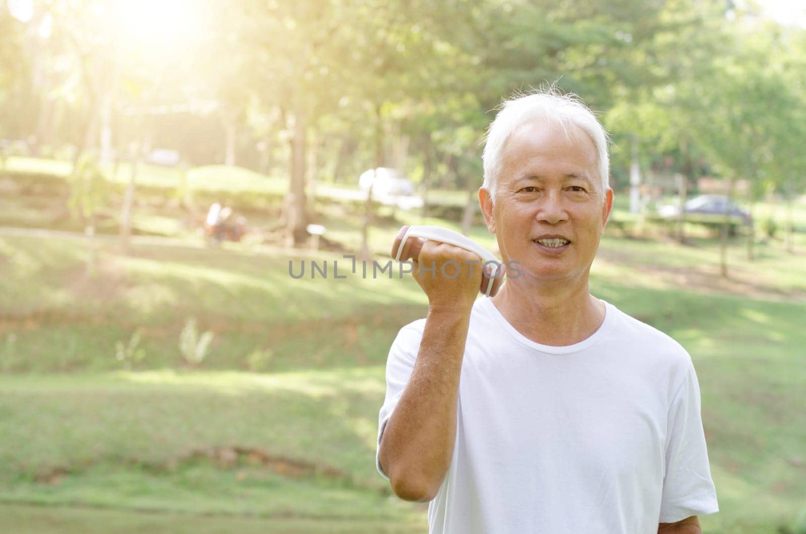 Portrait of healthy gray hair Asian old man workout at outdoor park in morning.