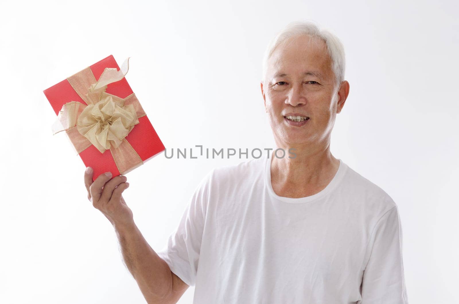 Portrait of old Asian man hand holding a gift box, isolated on white background.
