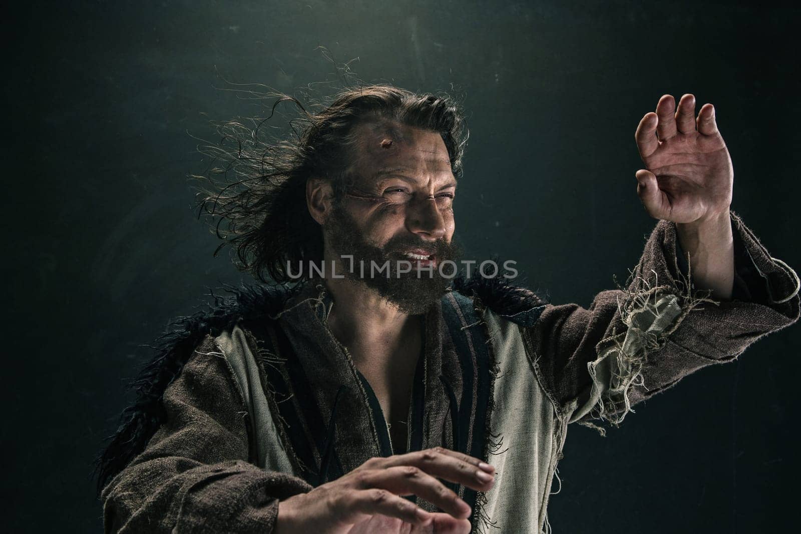 Portrait of a brutal bald-headed viking in a battle mail posing against a black background. Early medieval period.