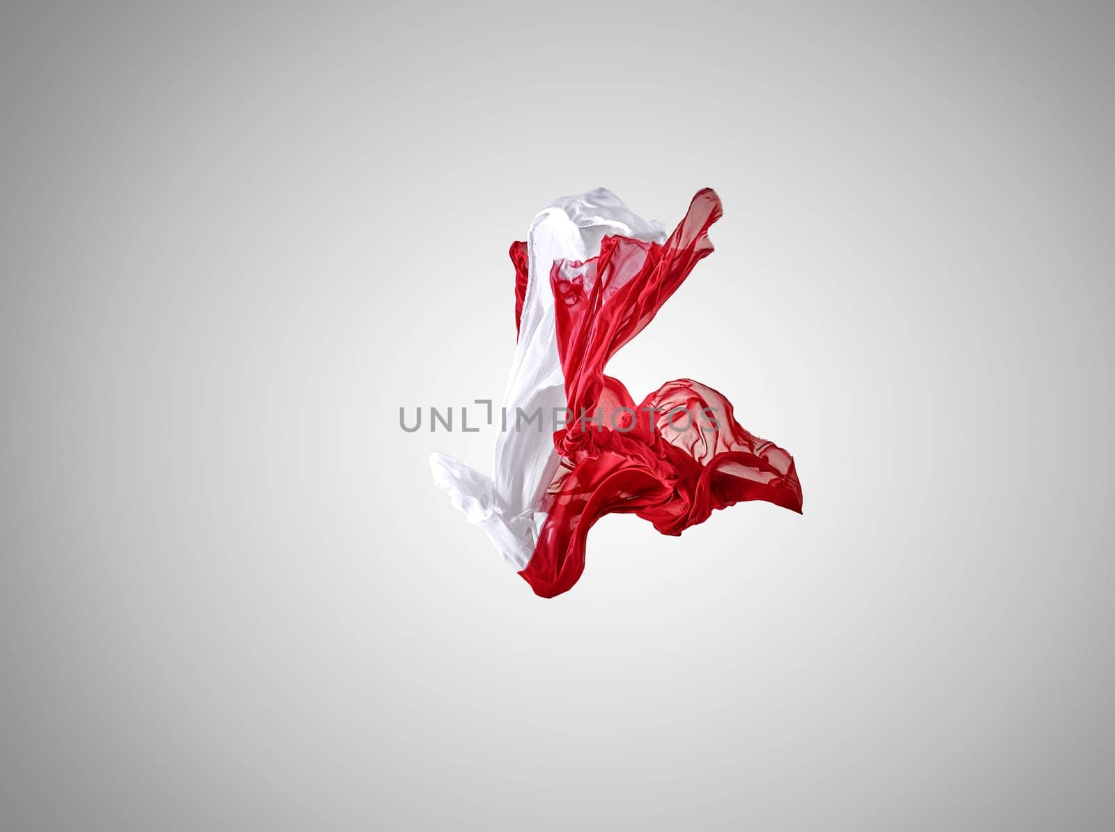 Smooth elegant transparent red and white cloth separated on gray background. Texture of flying fabric.