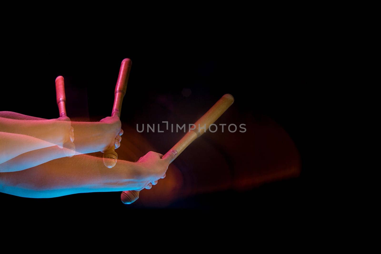 The male hands of table tennis player close up on black background. Stroboscope shooting technique