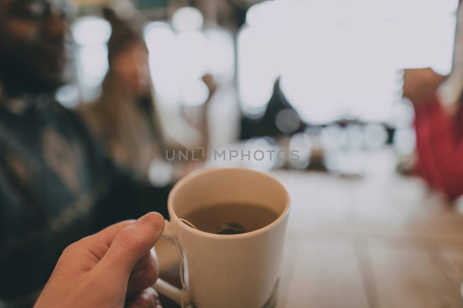Point of view hands holding a cup of coffee.