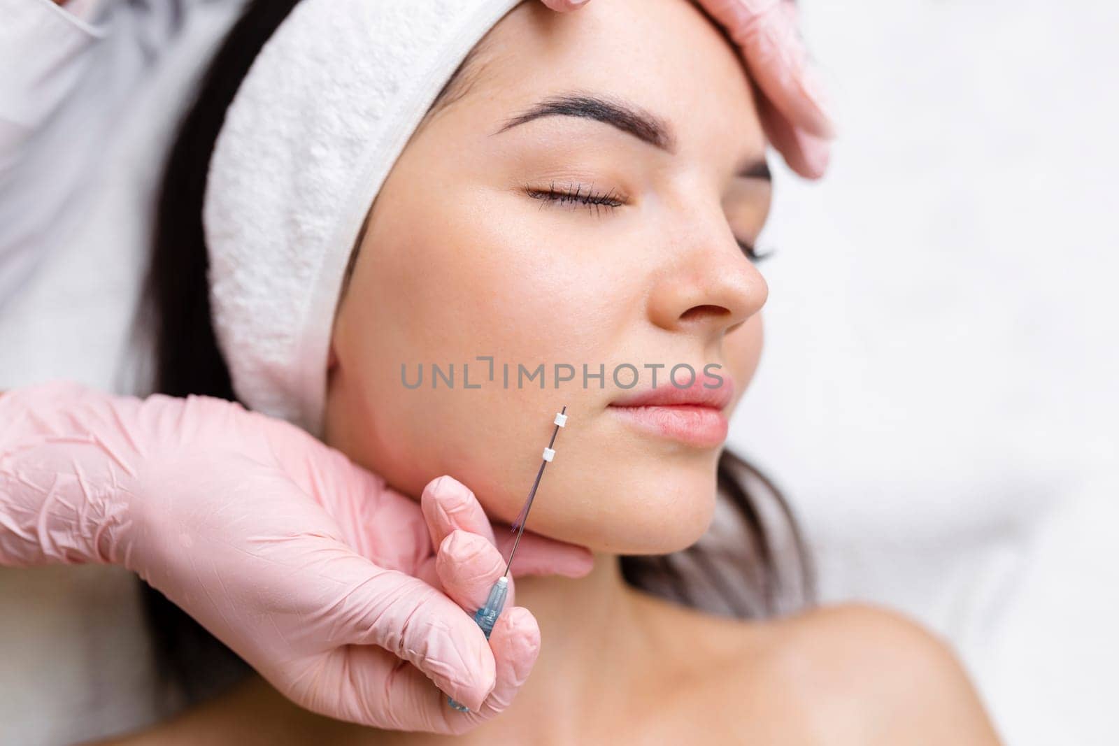 Face lifting PDO Suture operation. innovative technique of New thread lift, cosmetologist preparing to do procedure to female client, select the appropriate thread option.