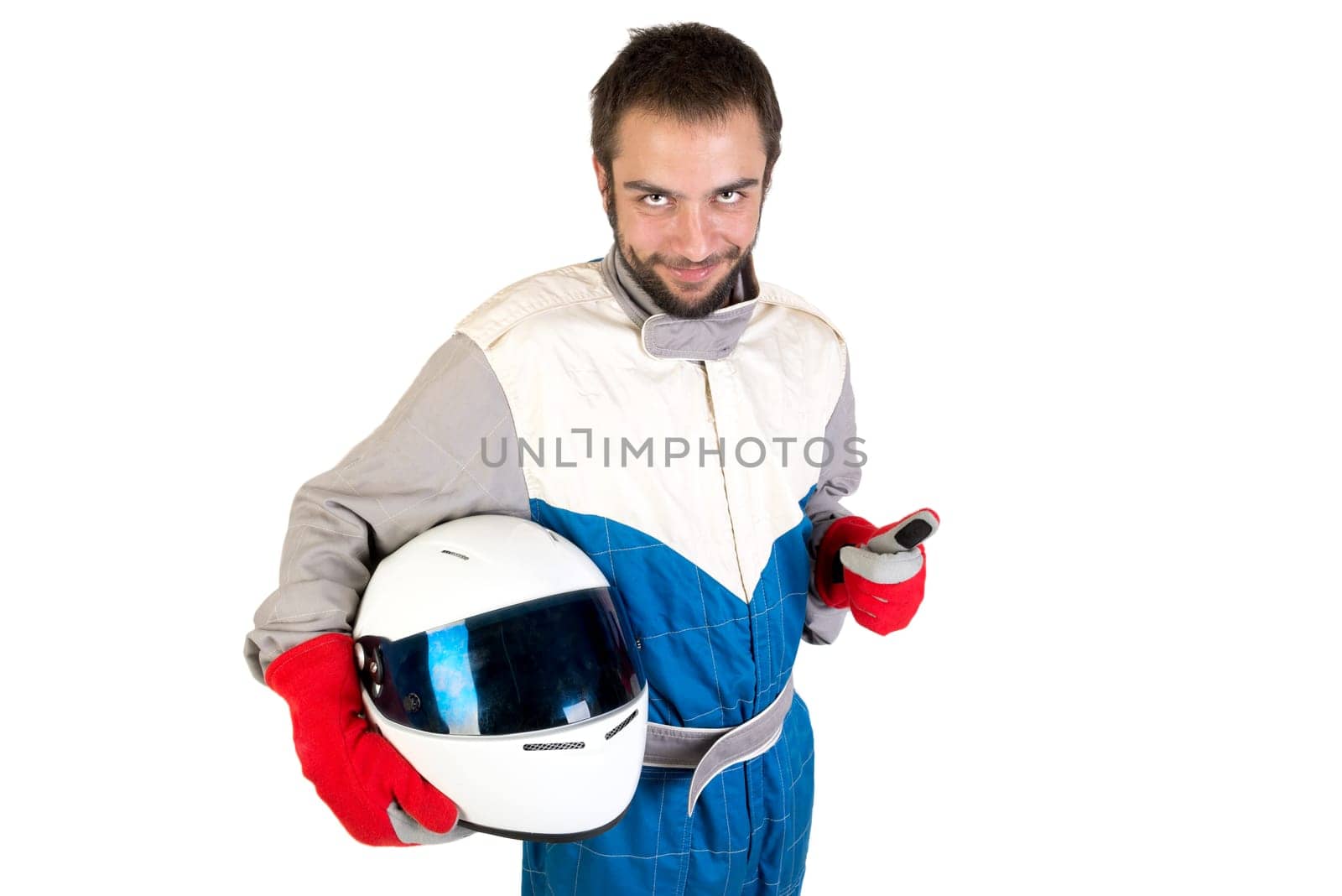 Racing driver posing with helmet isolated in white