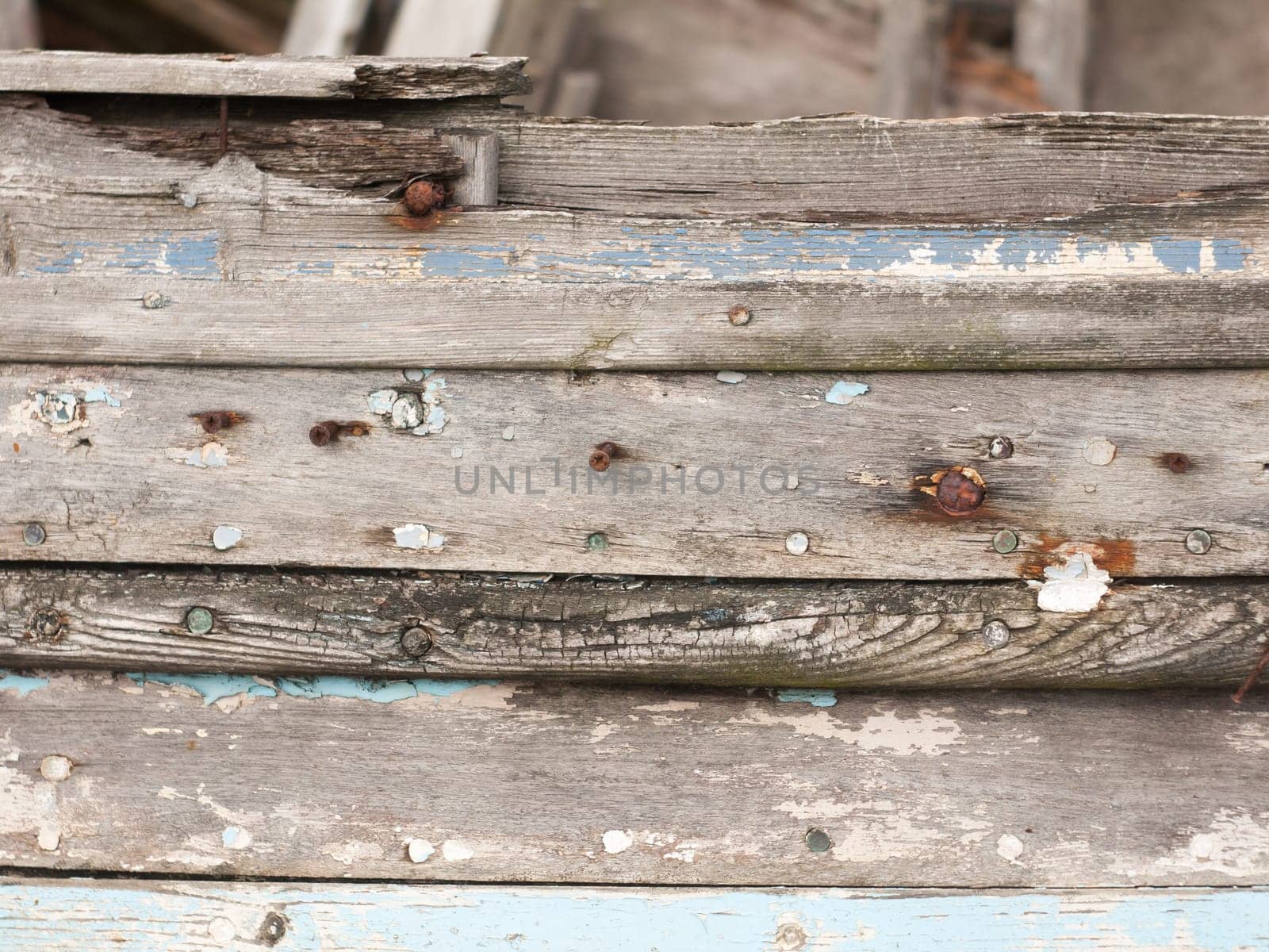 close up texture of decaying wooden boat with rusty nails