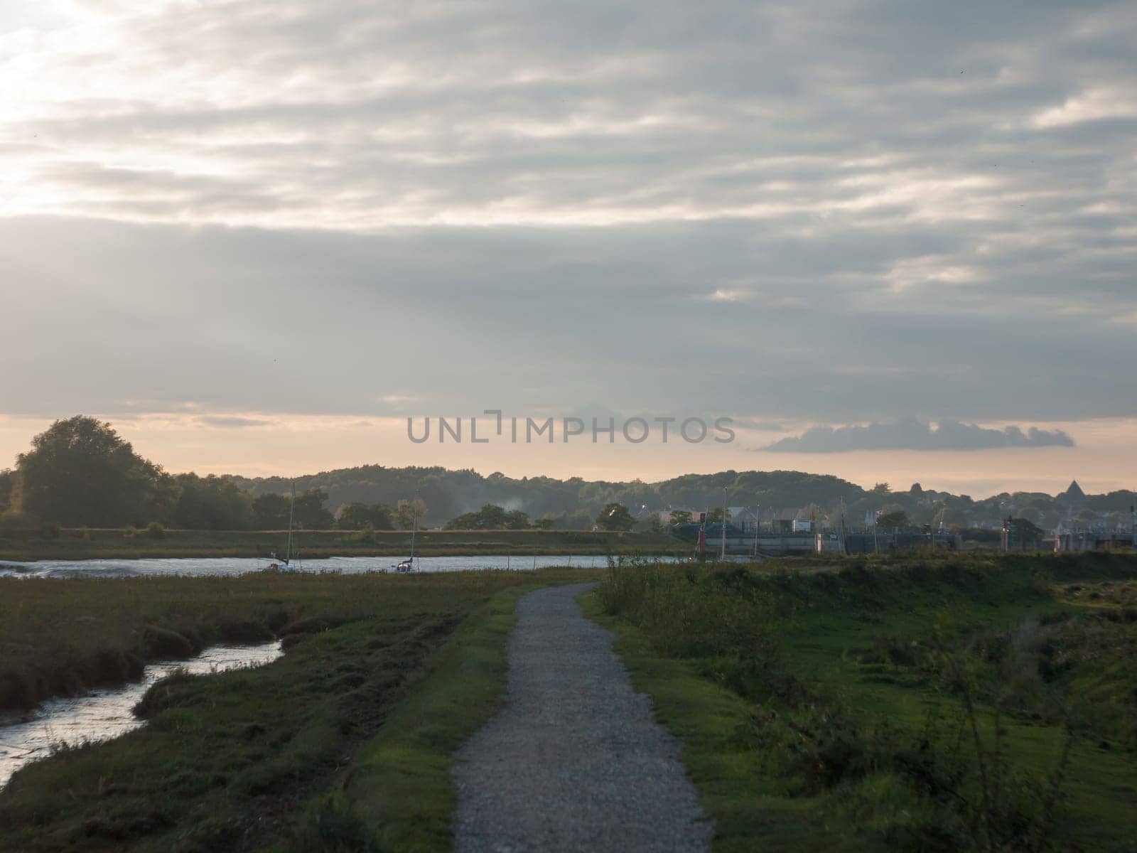 an empty country coastal walkway trail path outside low setting light  England  Essex