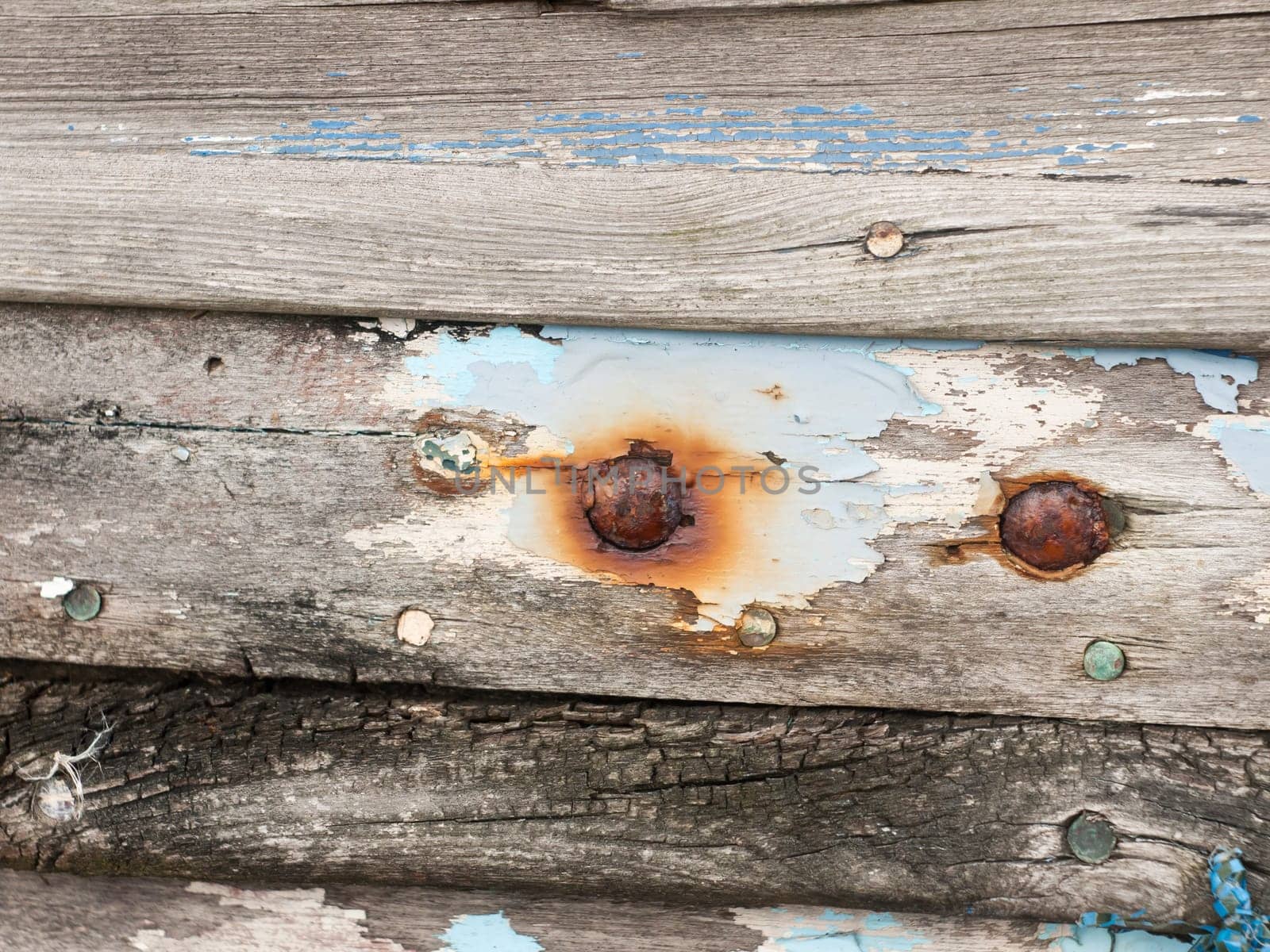 close up texture of decaying wooden boat with rusty nails