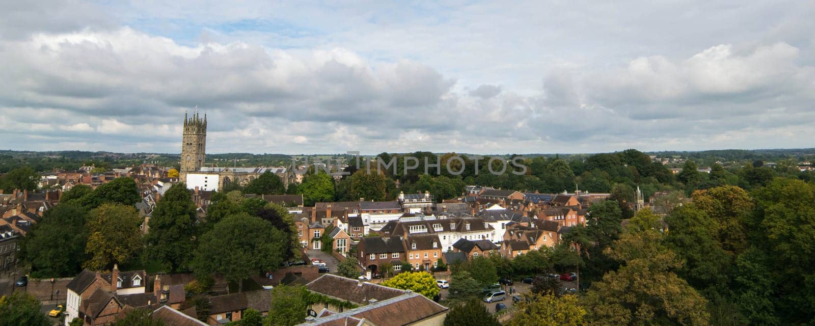 Warwick, United Kingdom - September 19, 2016: View of the Medieval castle tower and gatehouse from within the castle gardens and people enjoying the setting, Warwick, Warwickshire
