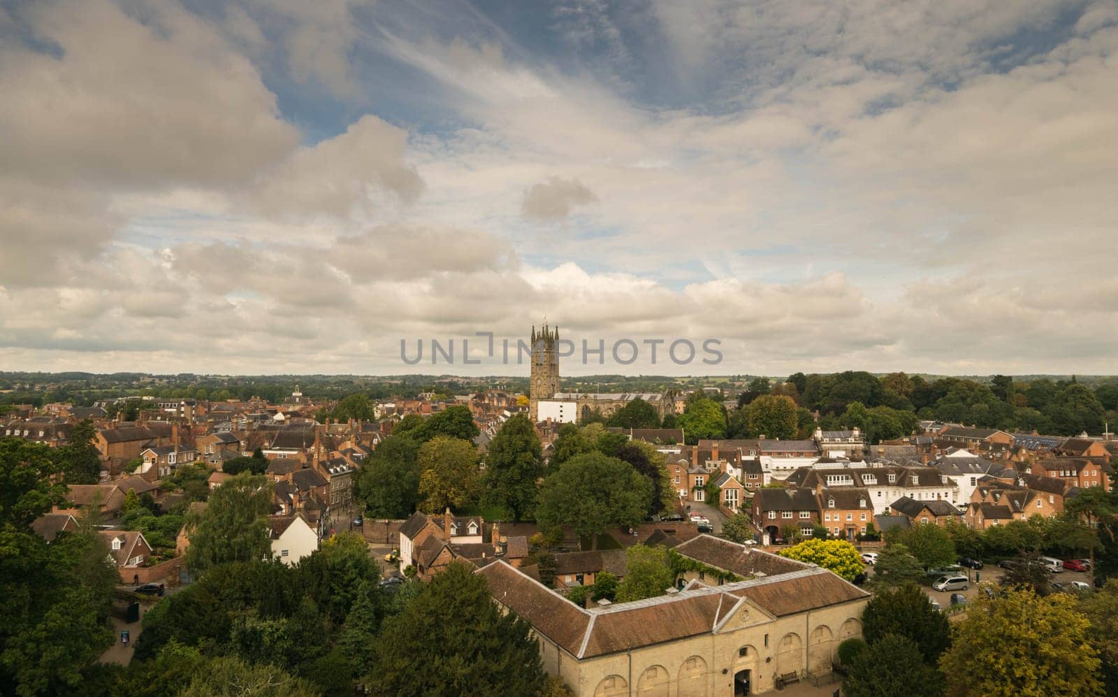 Warwick, United Kingdom - September 19, 2016: View of the Medieval castle tower and gatehouse from within the castle gardens and people enjoying the setting, Warwick, Warwickshire