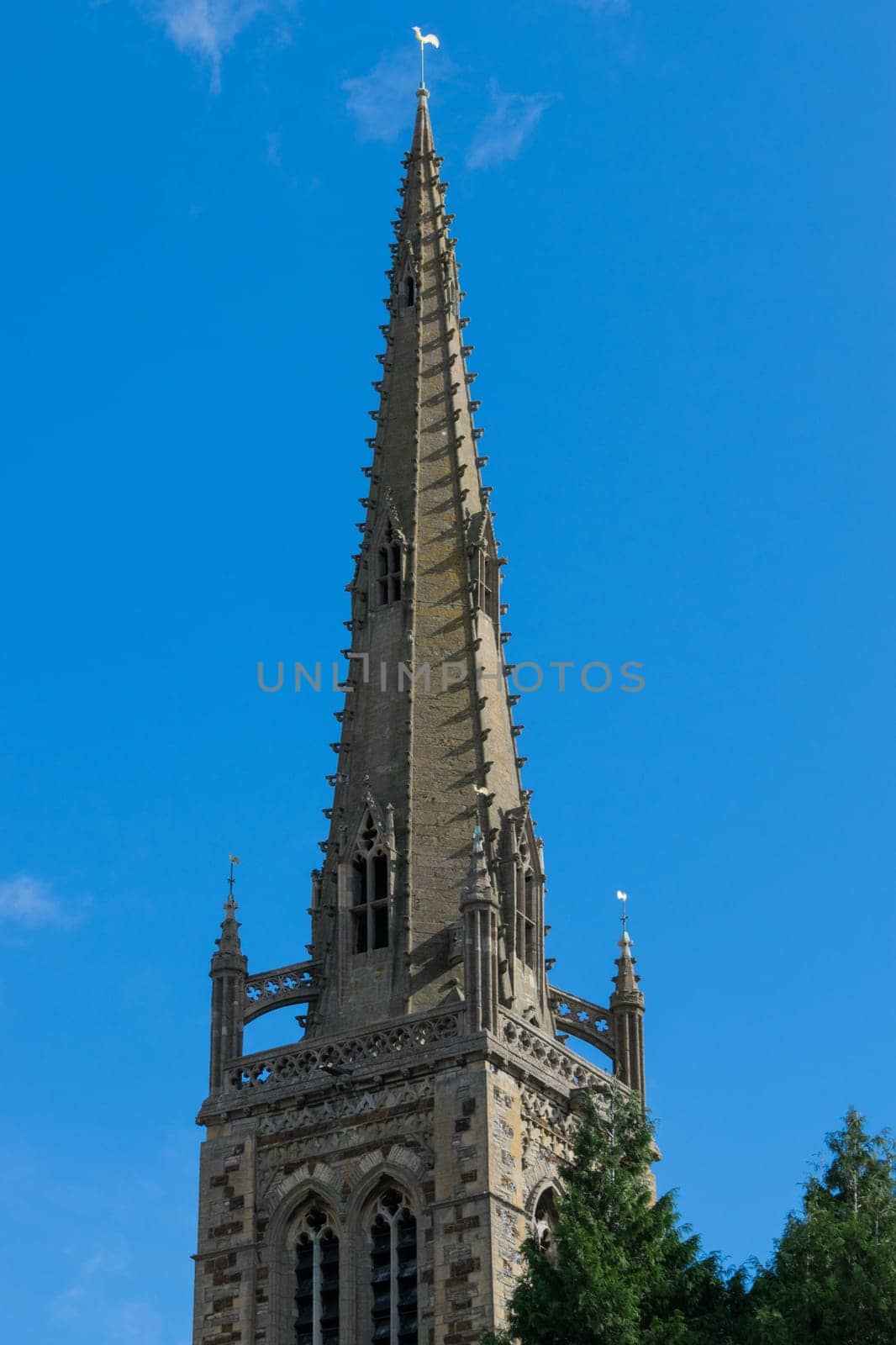 Warwick, United Kingdom - September 19, 2016: View of the Medieval castle tower and gatehouse from within the castle gardens and people enjoying the setting, Warwick, Warwickshire