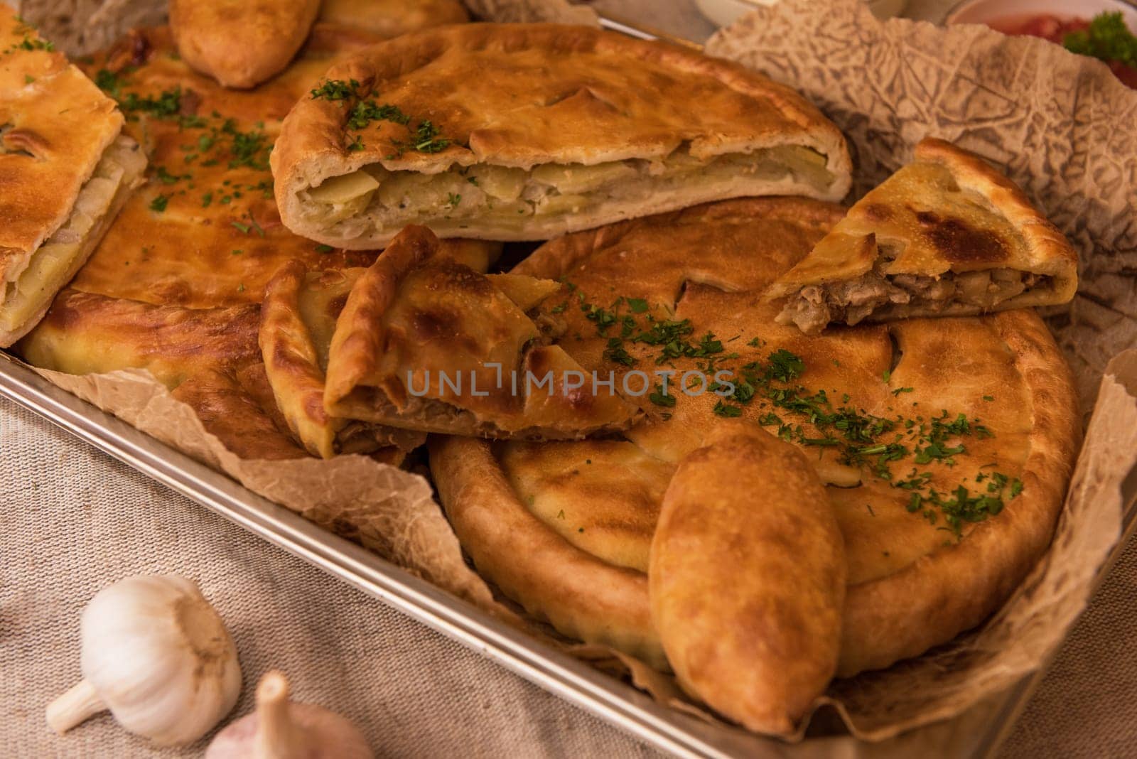 Different pies from meat and vegetables. Freshly baked cakes on a table