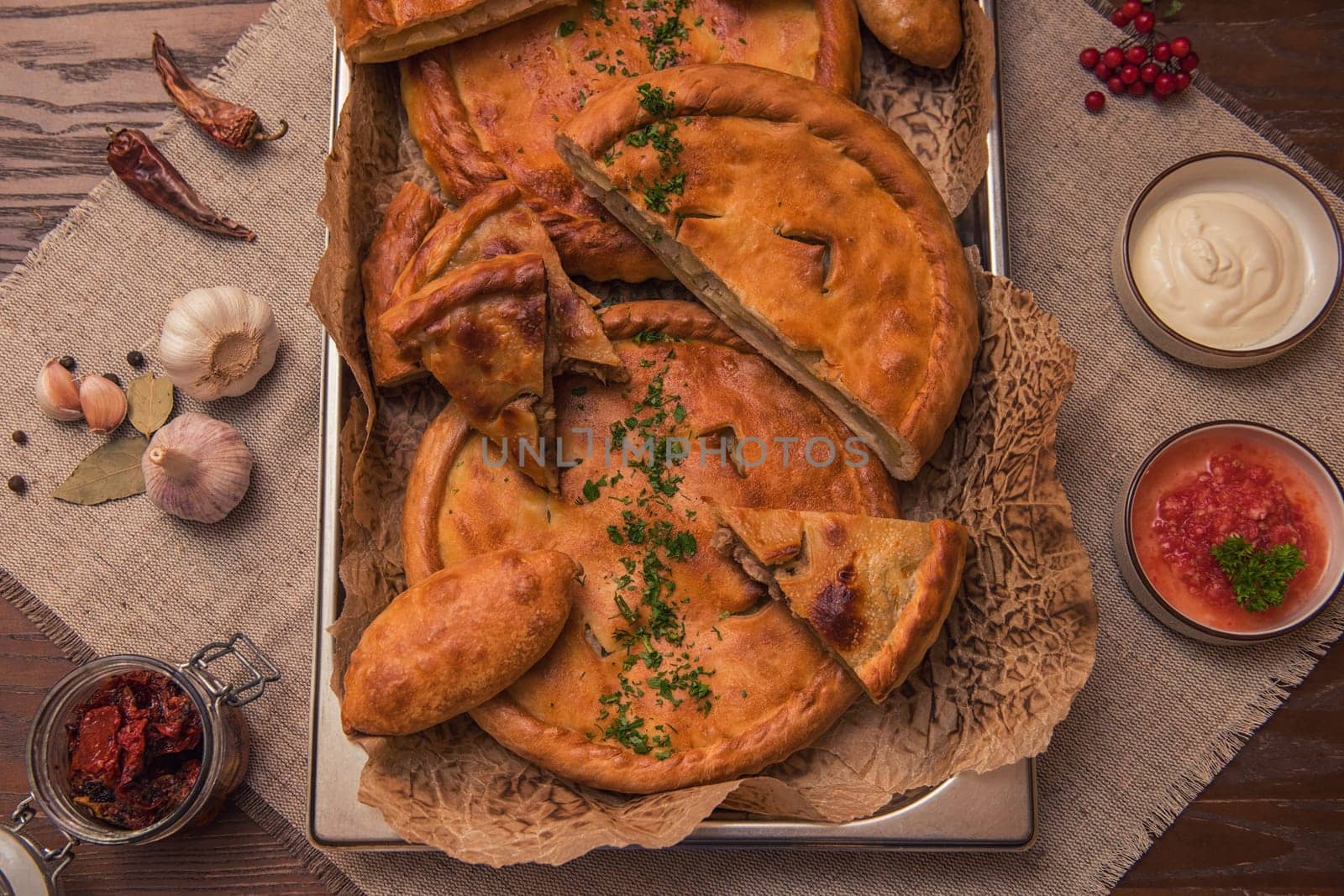 Different pies from meat and vegetables. Freshly baked cakes on a table