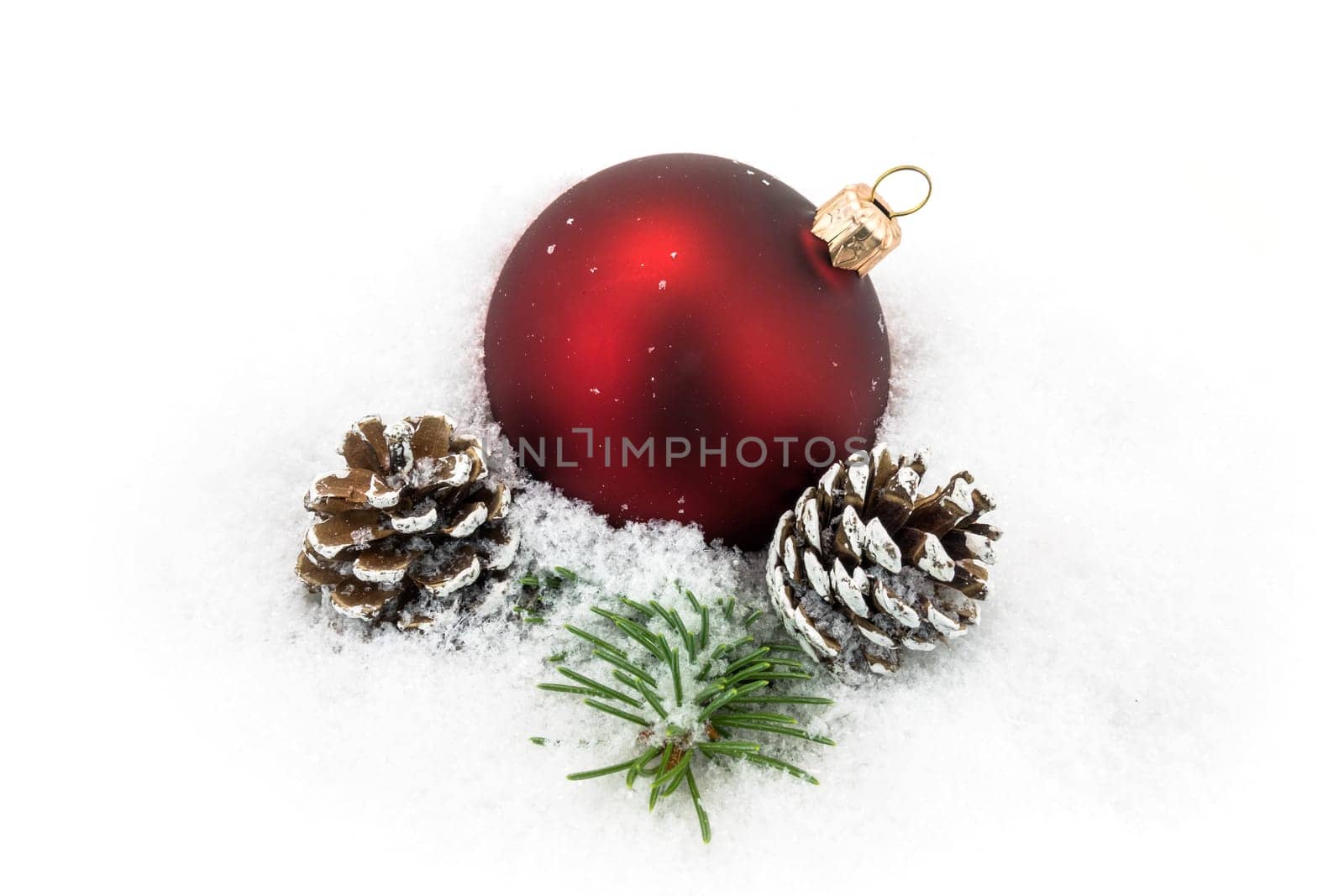 Christmas ball in the snow,Christmas decoration with pine cones and fir branch