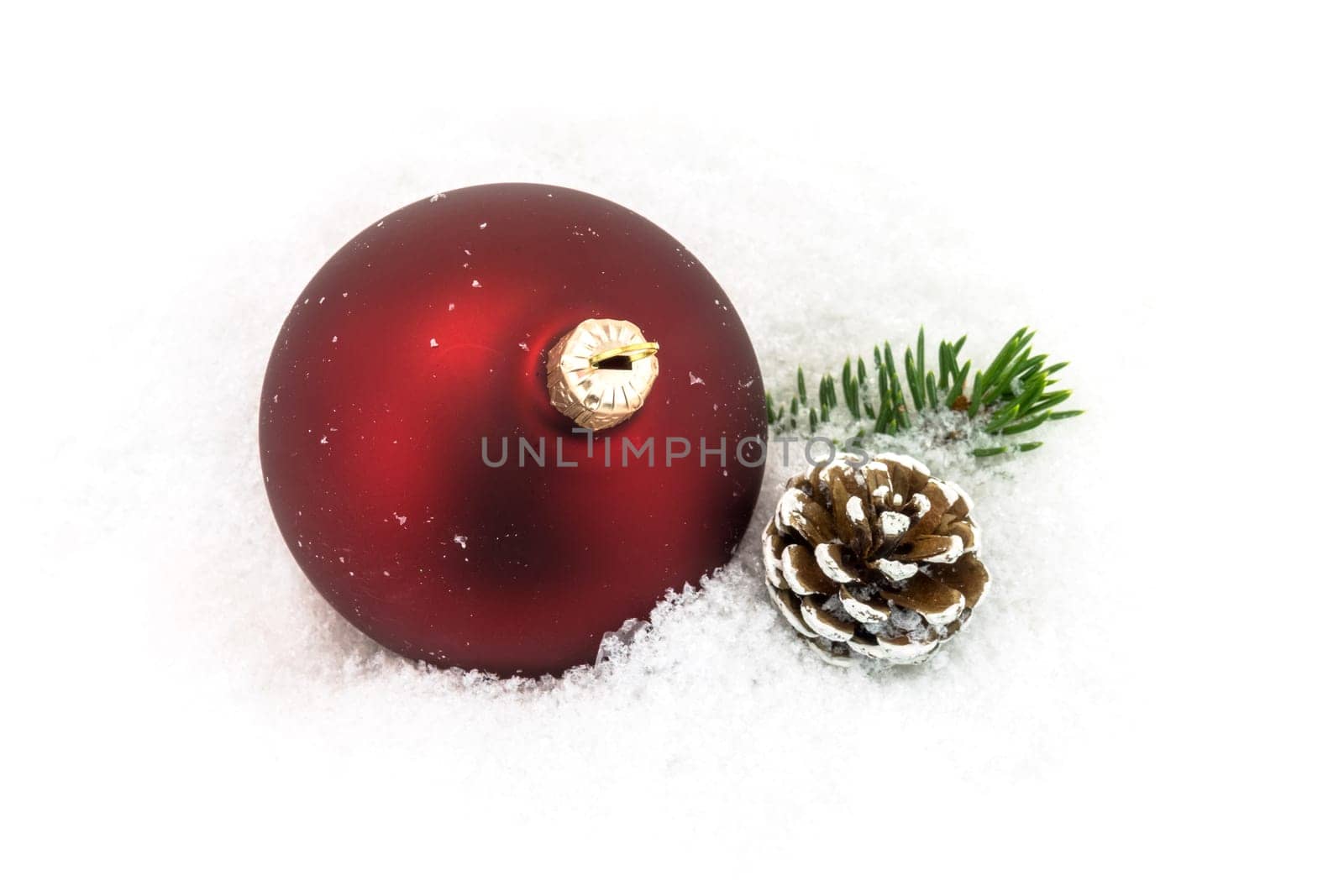 Christmas ball in the snow,Christmas decoration with pine cones and fir branch