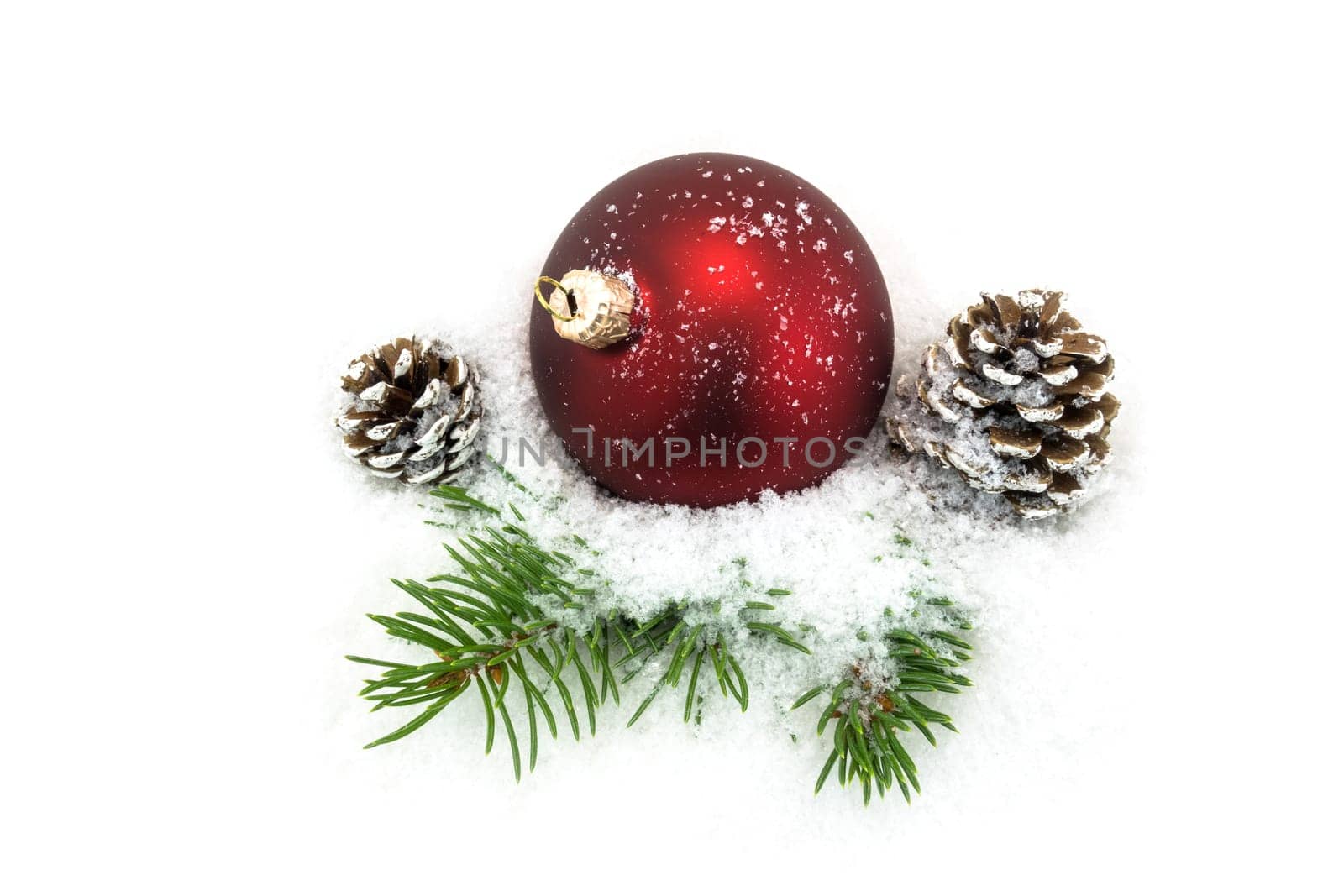 Christmas ball in the snow,Christmas decoration with pine cones and fir branch