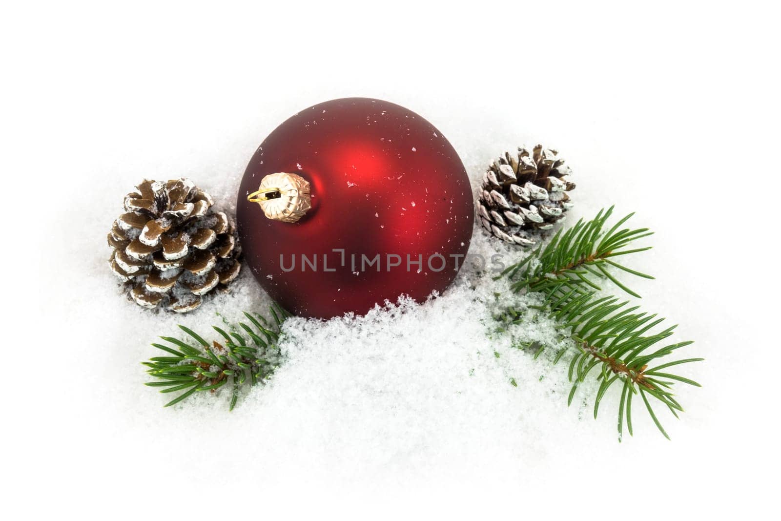 Christmas ball in the snow,Christmas decoration with pine cones and fir branch