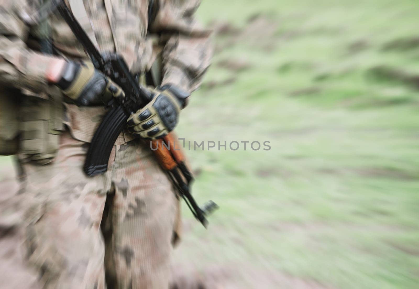 close up on soldier with machine gun,motion blur