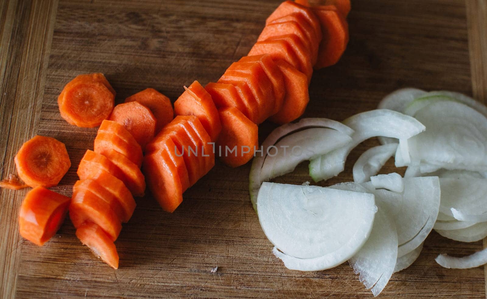 close up on carot and onion on wooden background