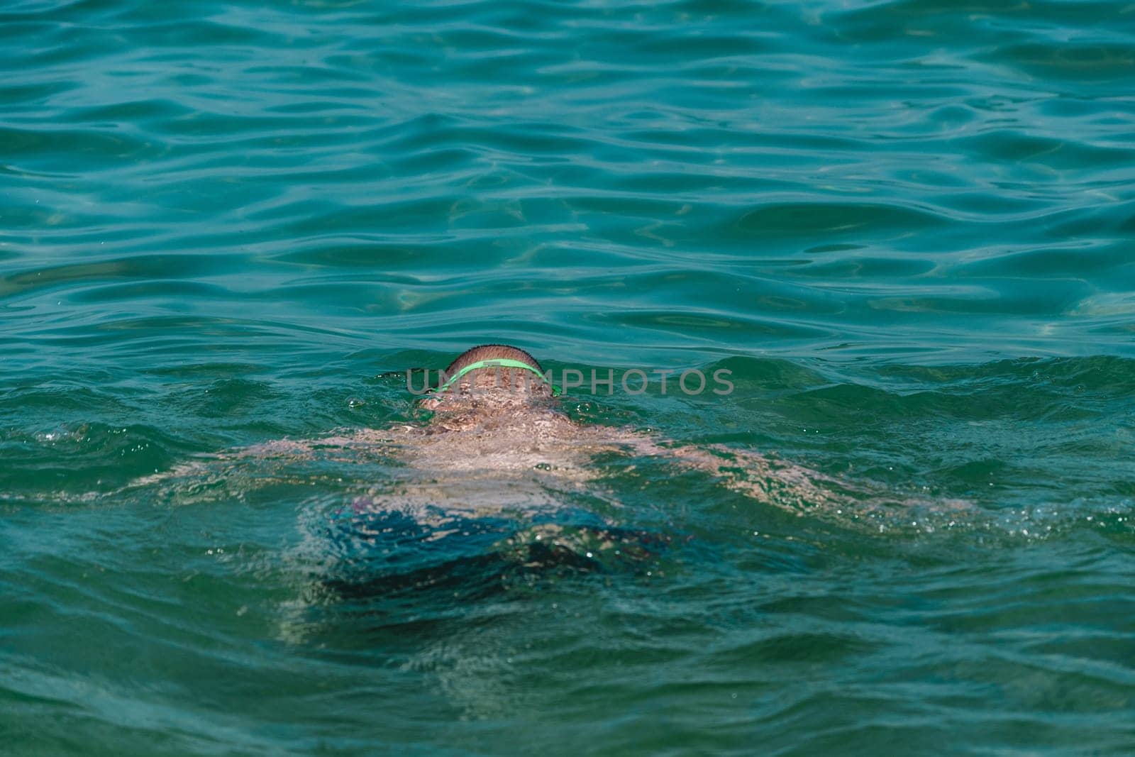 close up on swimming child in the water