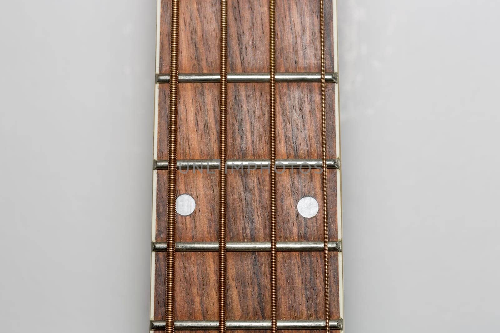 Acoustic Bass Guitar Fretboard Close Up.