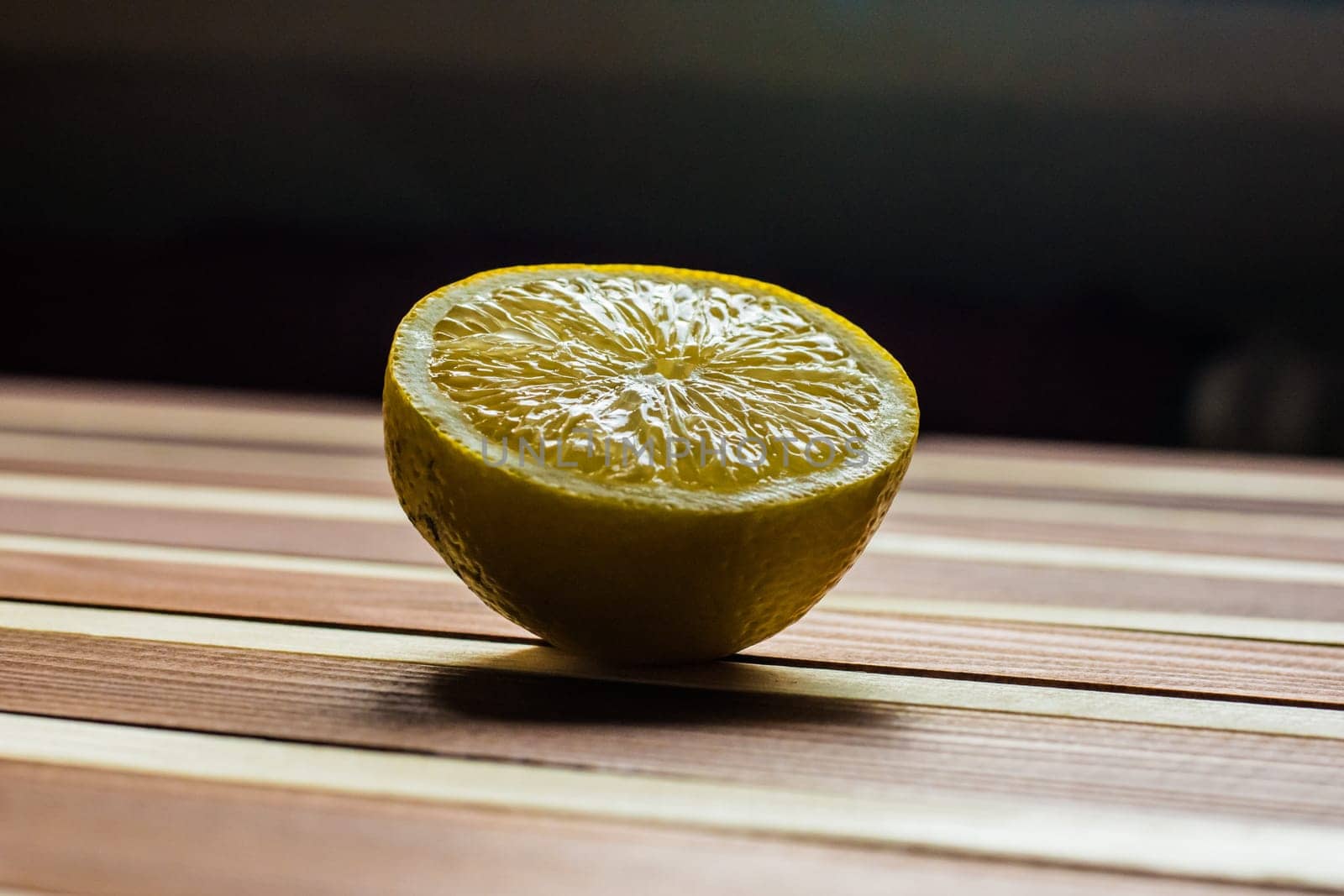 Lemon on the wooden table with dark background