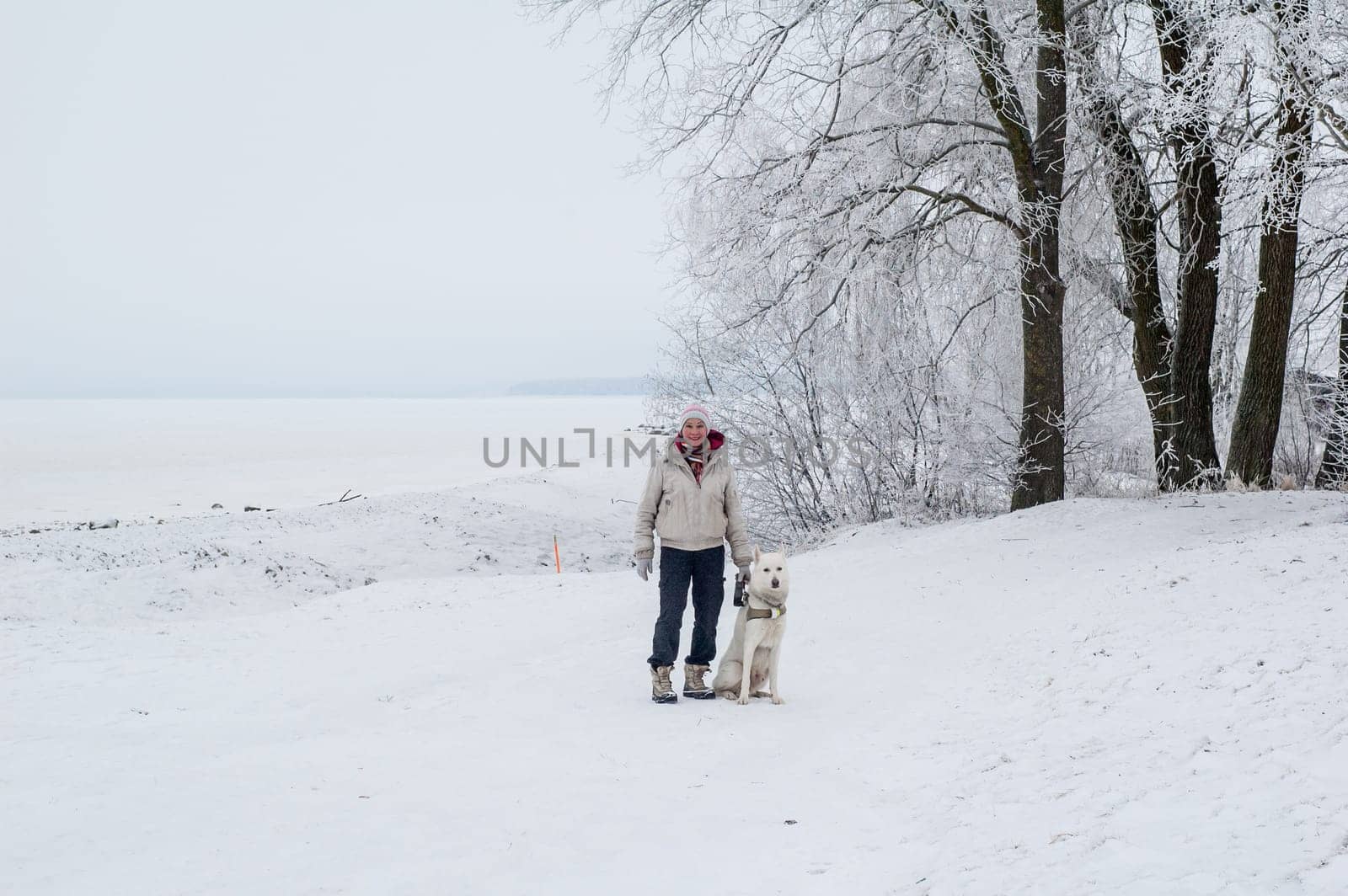 Woman walking with a dog in winter
