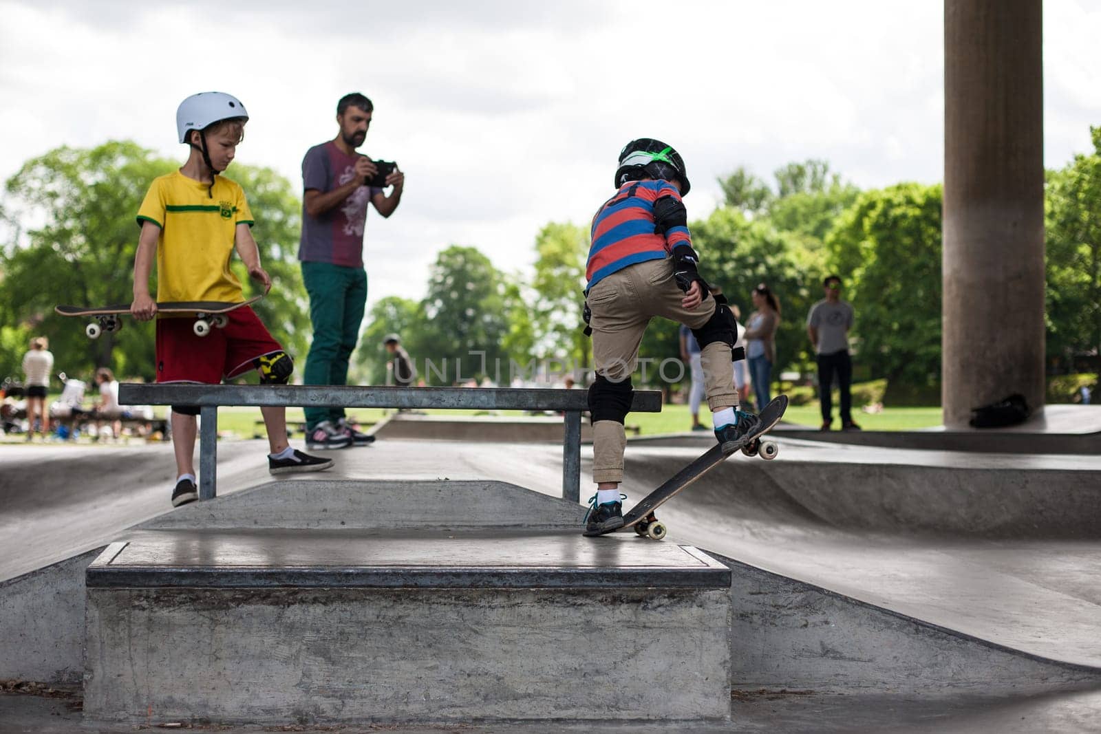 Stockholm, Sweden - July 11, 2017 : Powerful funny young guys are trained in a skate park. Leisure, playing, trick