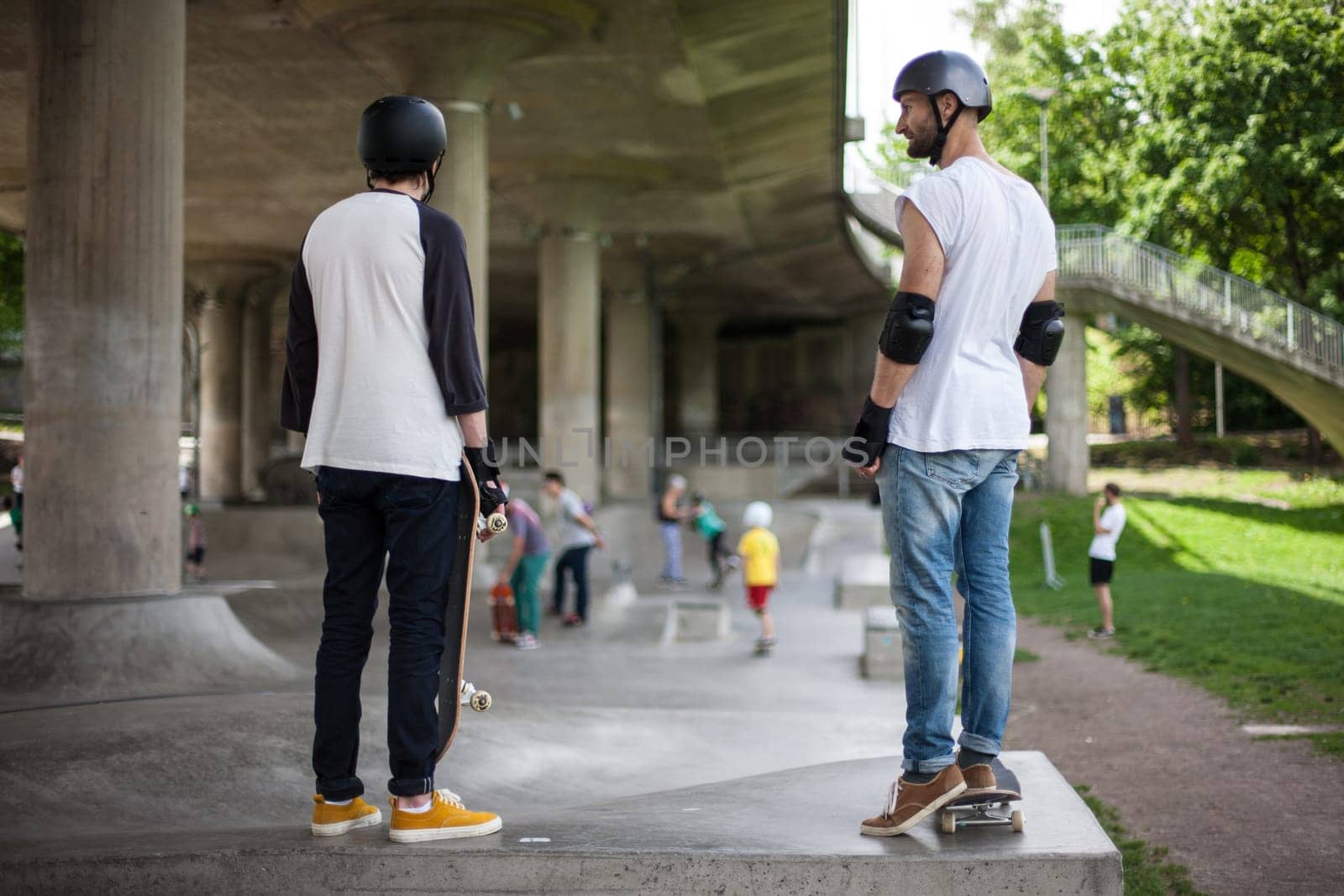 Stockholm, Sweden - July 11, 2017 : Powerful funny young guys are trained in a skate park. Leisure, playing, trick