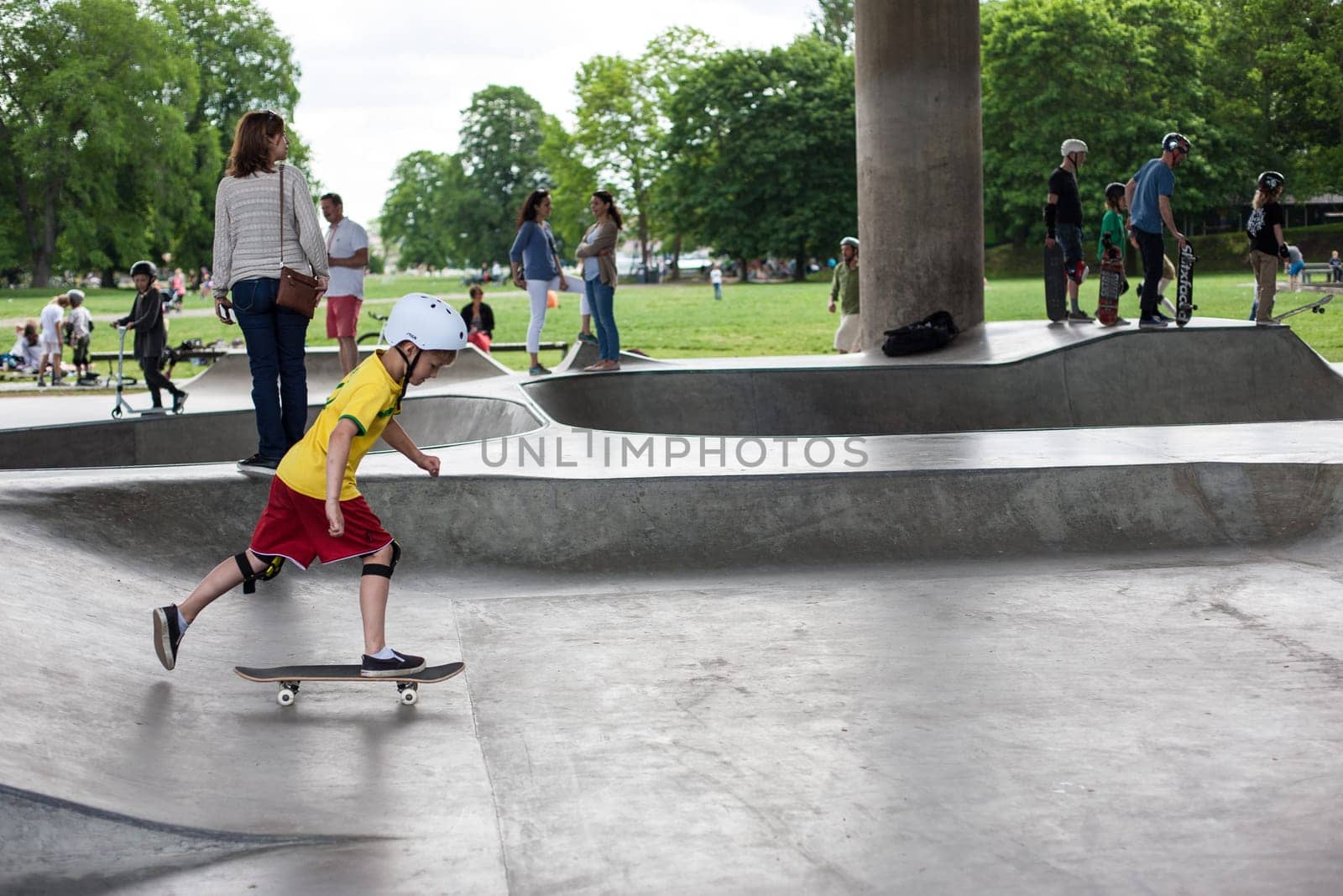 Stockholm, Sweden - July 11, 2017 : Powerful funny young guys are trained in a skate park. Leisure, playing, trick
