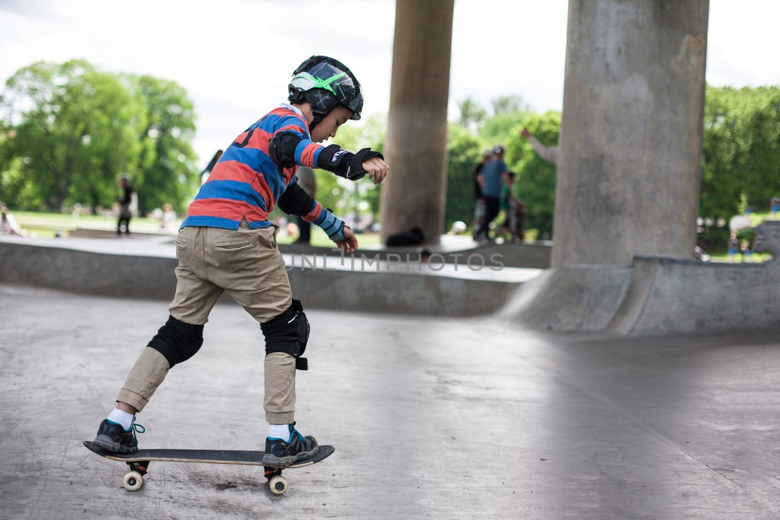 Stockholm, Sweden - July 11, 2017 : Powerful funny young guys are trained in a skate park. Leisure, playing, trick