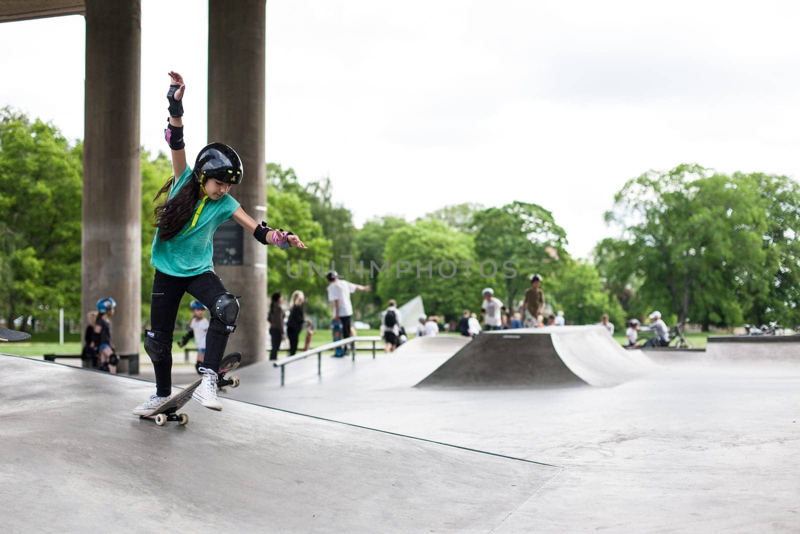 Stockholm, Sweden - July 11, 2017 : Powerful funny young guys are trained in a skate park. Leisure, playing, trick
