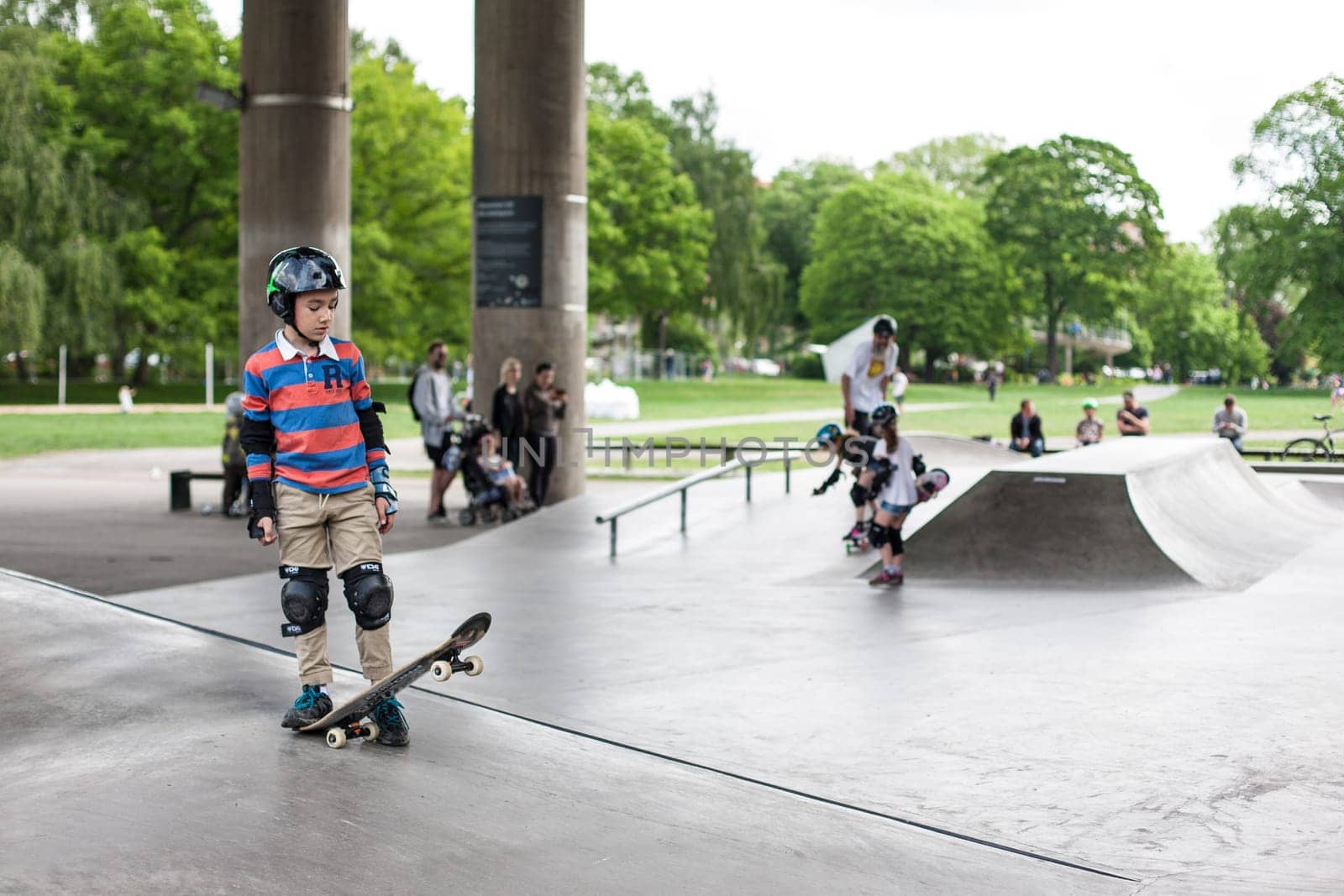 Stockholm, Sweden - July 11, 2017 : Powerful funny young guys are trained in a skate park. Leisure, playing, trick