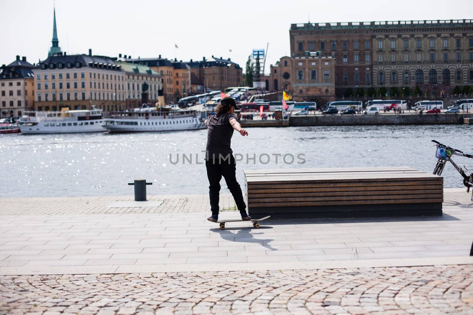 Stockholm, Sweden - June 10, 2017 : Urban life. Cool skateboarder outdoors Scandinavian guy performing a trick with his skate on the street