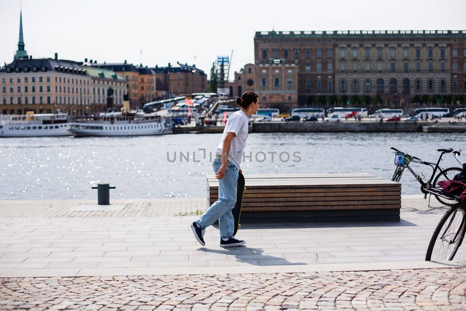 Stockholm, Sweden - June 10, 2017 : Urban life. Cool skateboarder outdoors Scandinavian guy performing a trick with his skate on the street