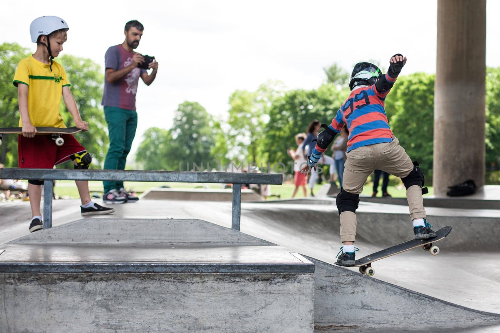 Stockholm, Sweden - July 11, 2017 : Powerful funny young guys are trained in a skate park. Leisure, playing, trick