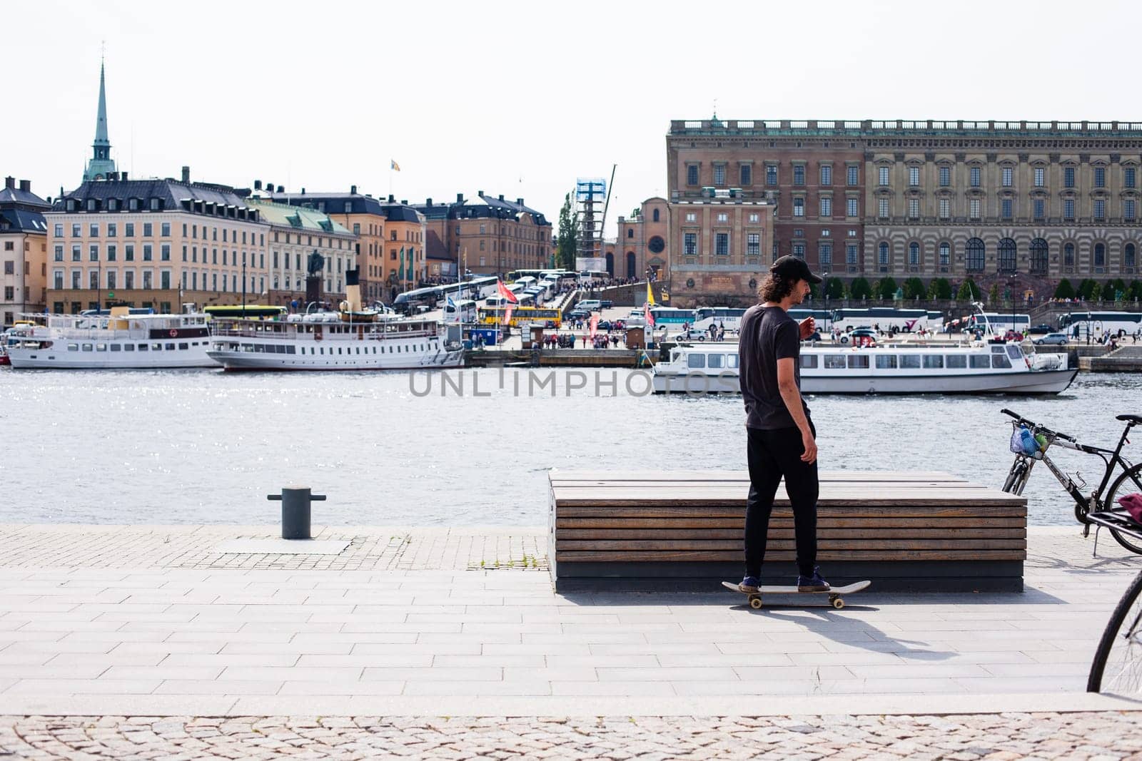 Stockholm, Sweden - June 10, 2017 : Urban life. Cool skateboarder outdoors Scandinavian guy performing a trick with his skate on the street