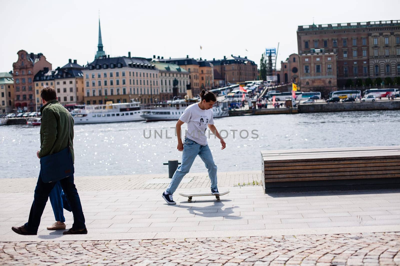 Stockholm, Sweden - June 10, 2017 : Urban life. Cool skateboarder outdoors Scandinavian guy performing a trick with his skate on the street