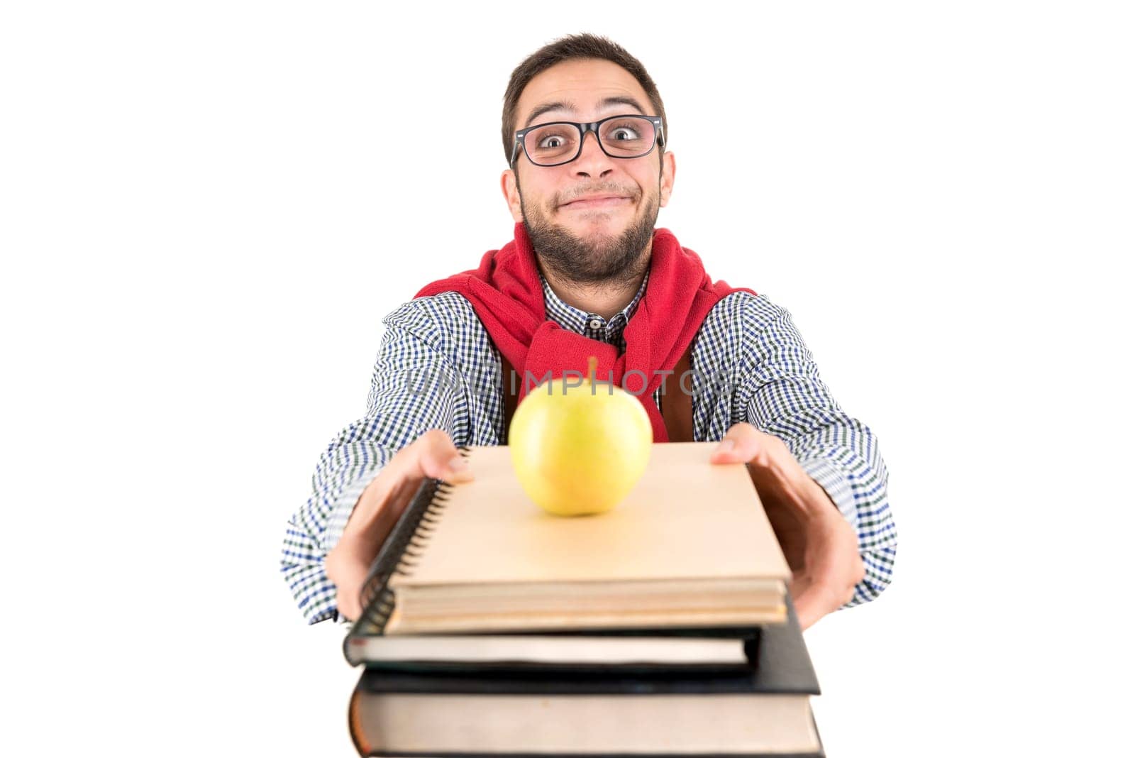 Young nerd student posing with books and apple isolated in a white background