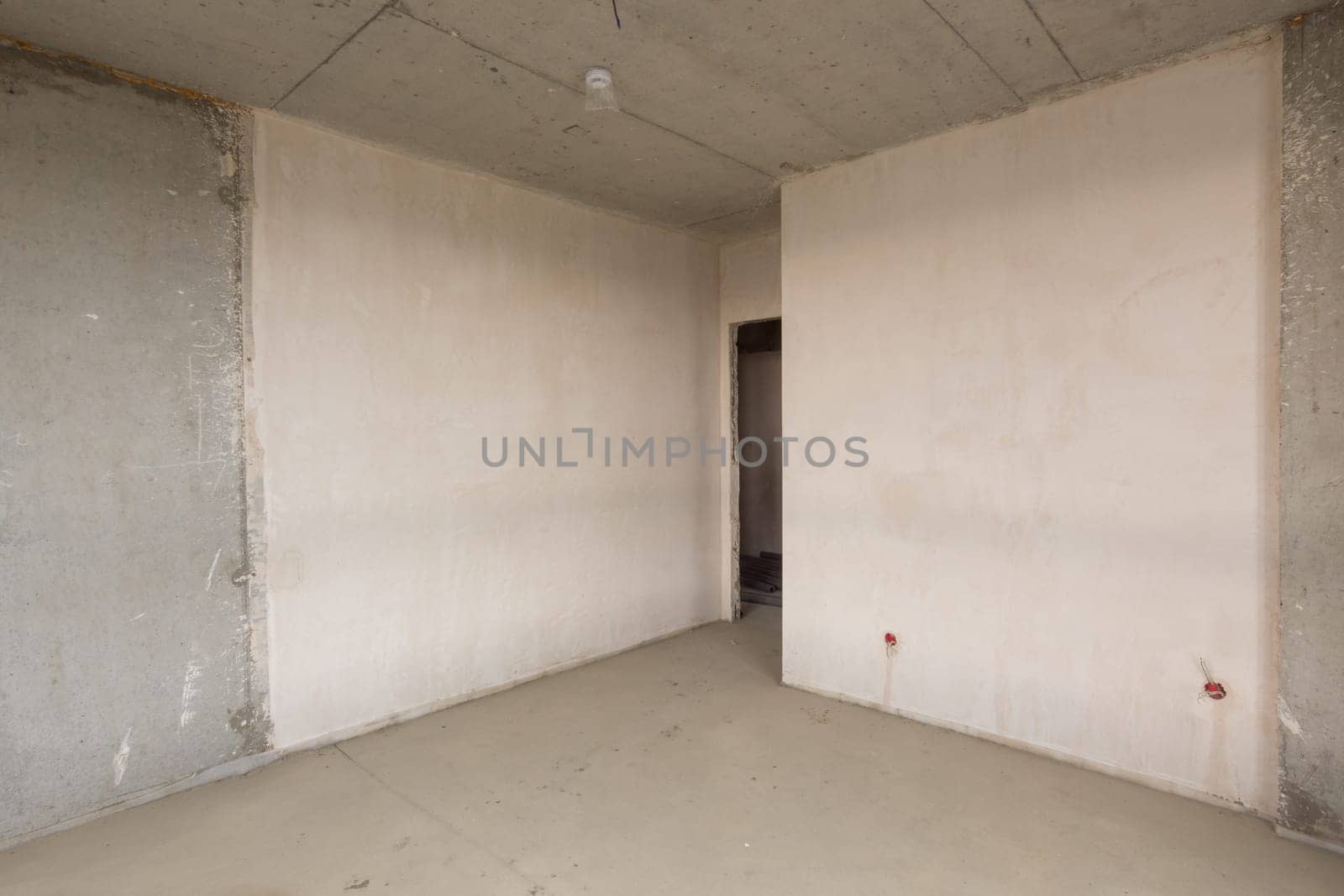 Entrance to the room in the new building, plastered and concrete walls