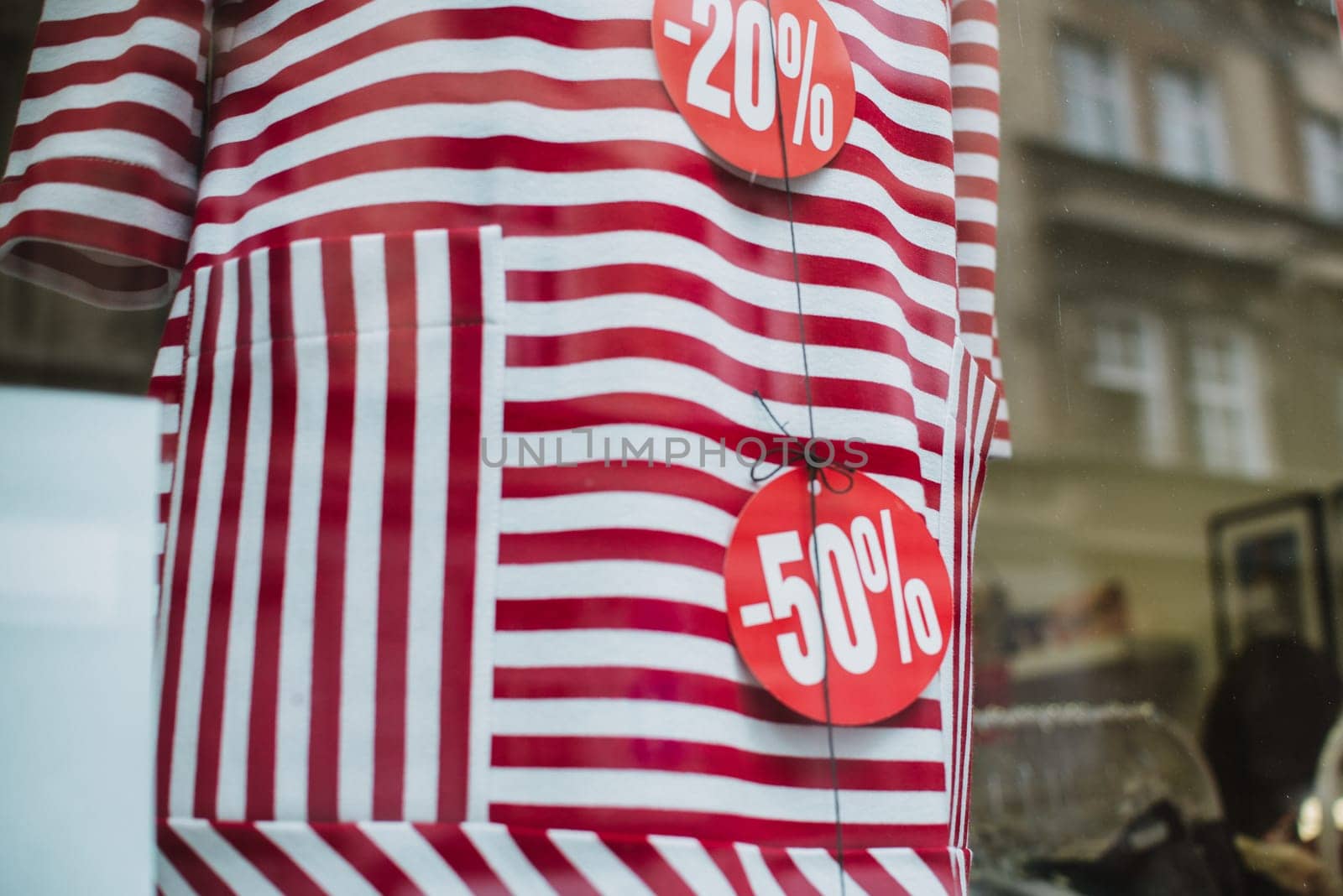 discount price on the red dress. outside the window with city reflection